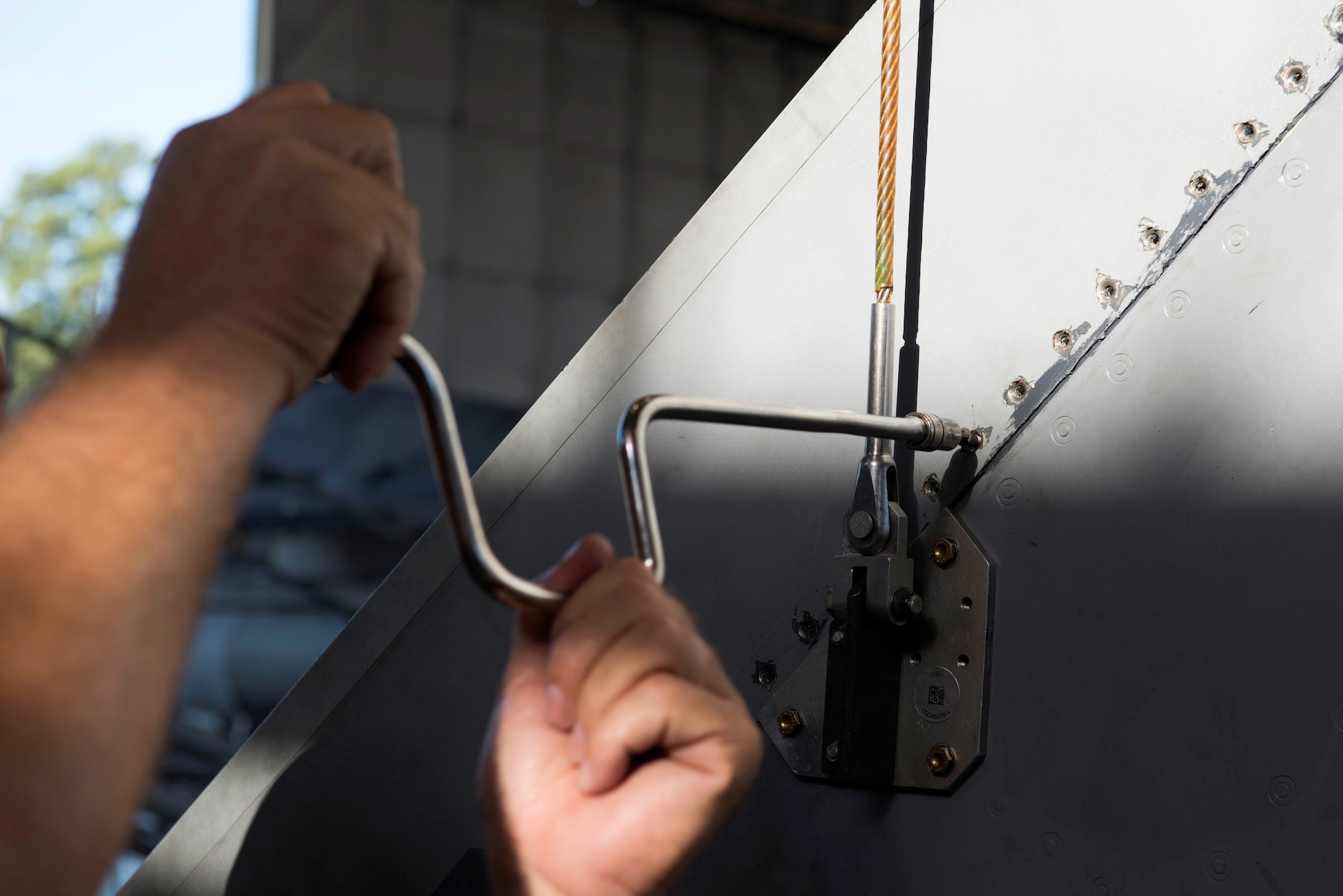 Albert McPherson, 20th Aircraft Maintenance Squadron Air Force engineering and technical services equipment specialist shift lead, tightens screws on the vertical stabilizer of an F-16 Fighting Falcon at Shaw Air Force Base, S.C., Sept. 11, 2018.