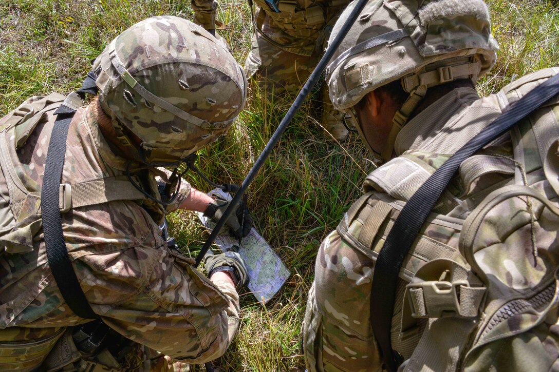 Soldiers review a map to coordinate a route to their follow-on objective during air assault training.