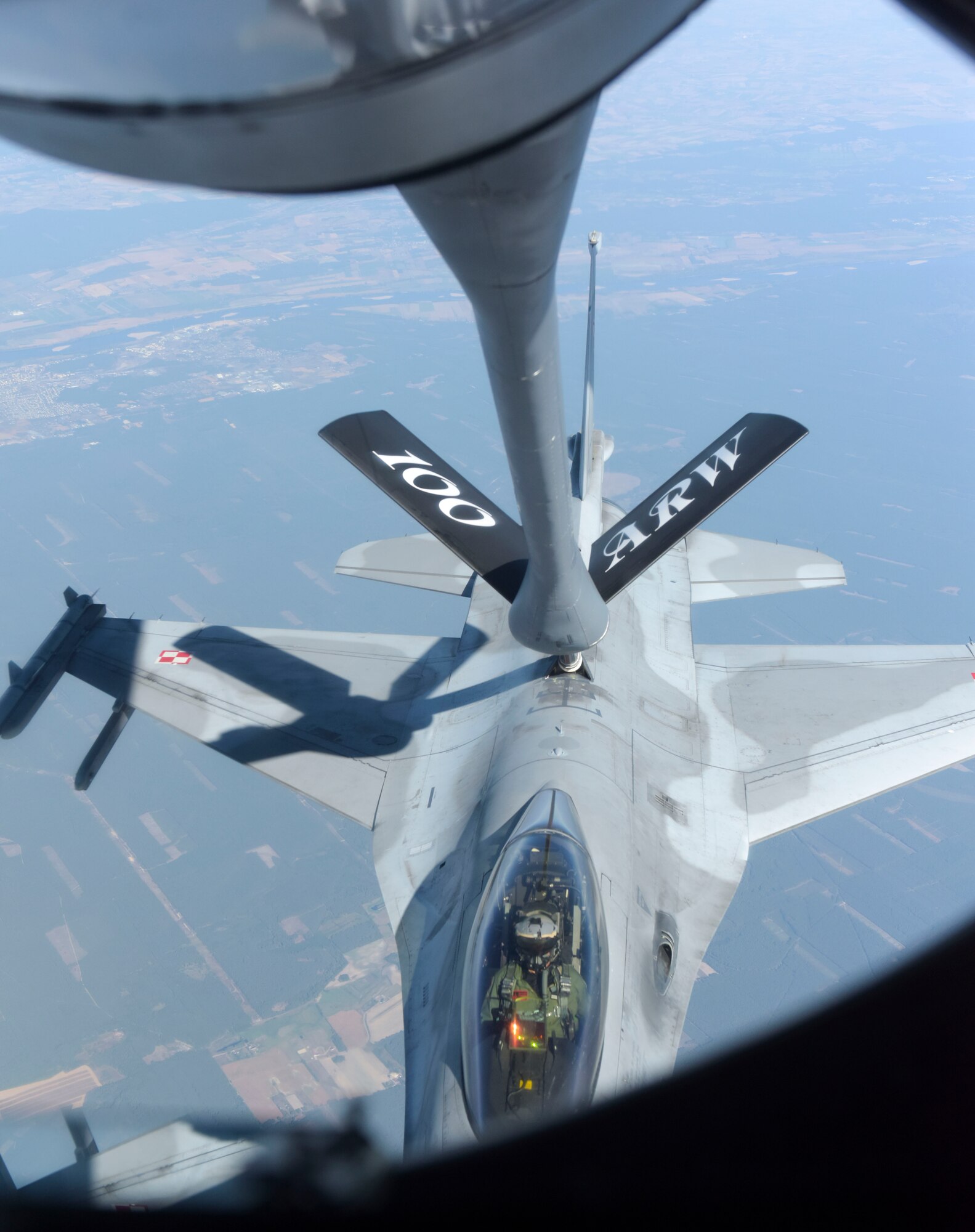 A U.S. Air Force KC- 135 Stratotanker from the 100th Air Refueling Wing refuels a Polish air force F-16 Fighting Falcon in support of exercise One Sky over Poland, Sept. 19, 2018. One Sky exercises focuses on interoperability with our Polish counterparts and enhanced the operational readiness of both nations. (U.S. Air Force photo by Airman 1st Class Alexandria Lee)