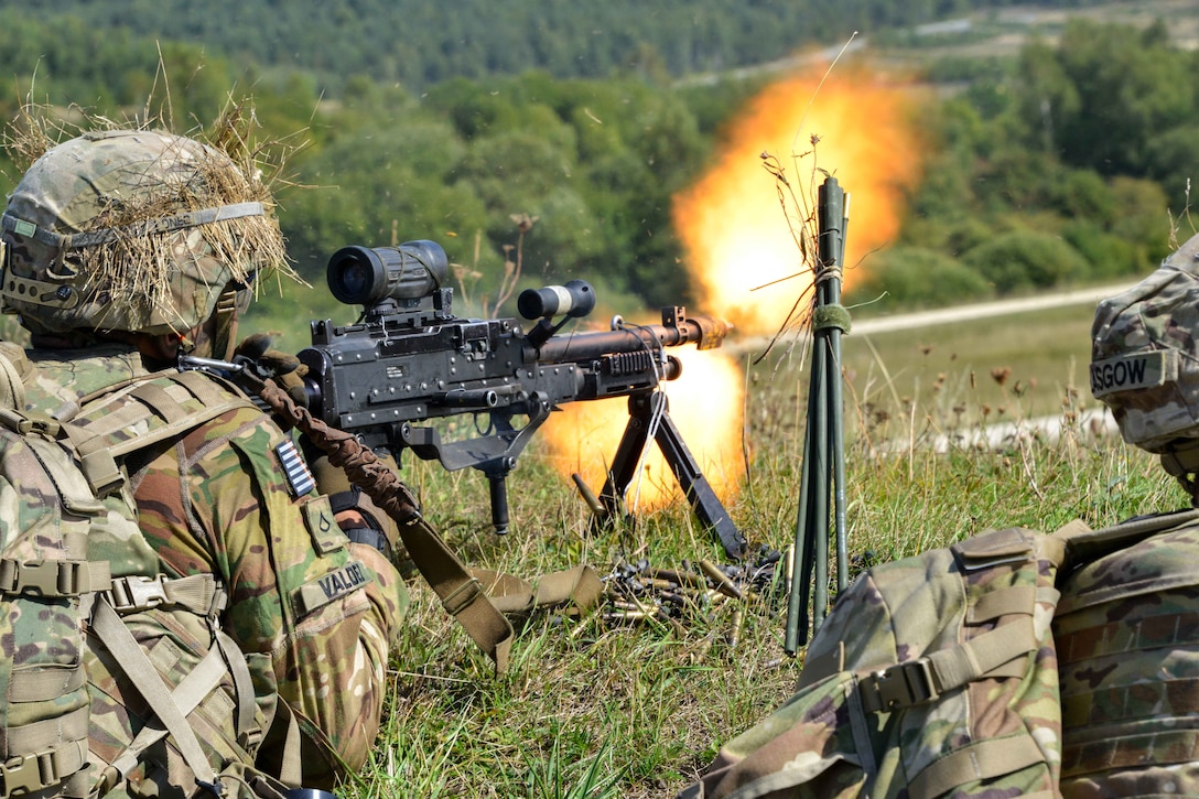 A soldier fires an M240B machine gun during air assault training.