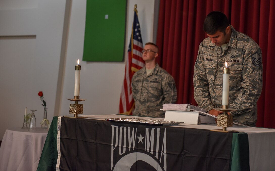Airmen recite POW/MIA service members names and stand guard over the POW/MIA table.
