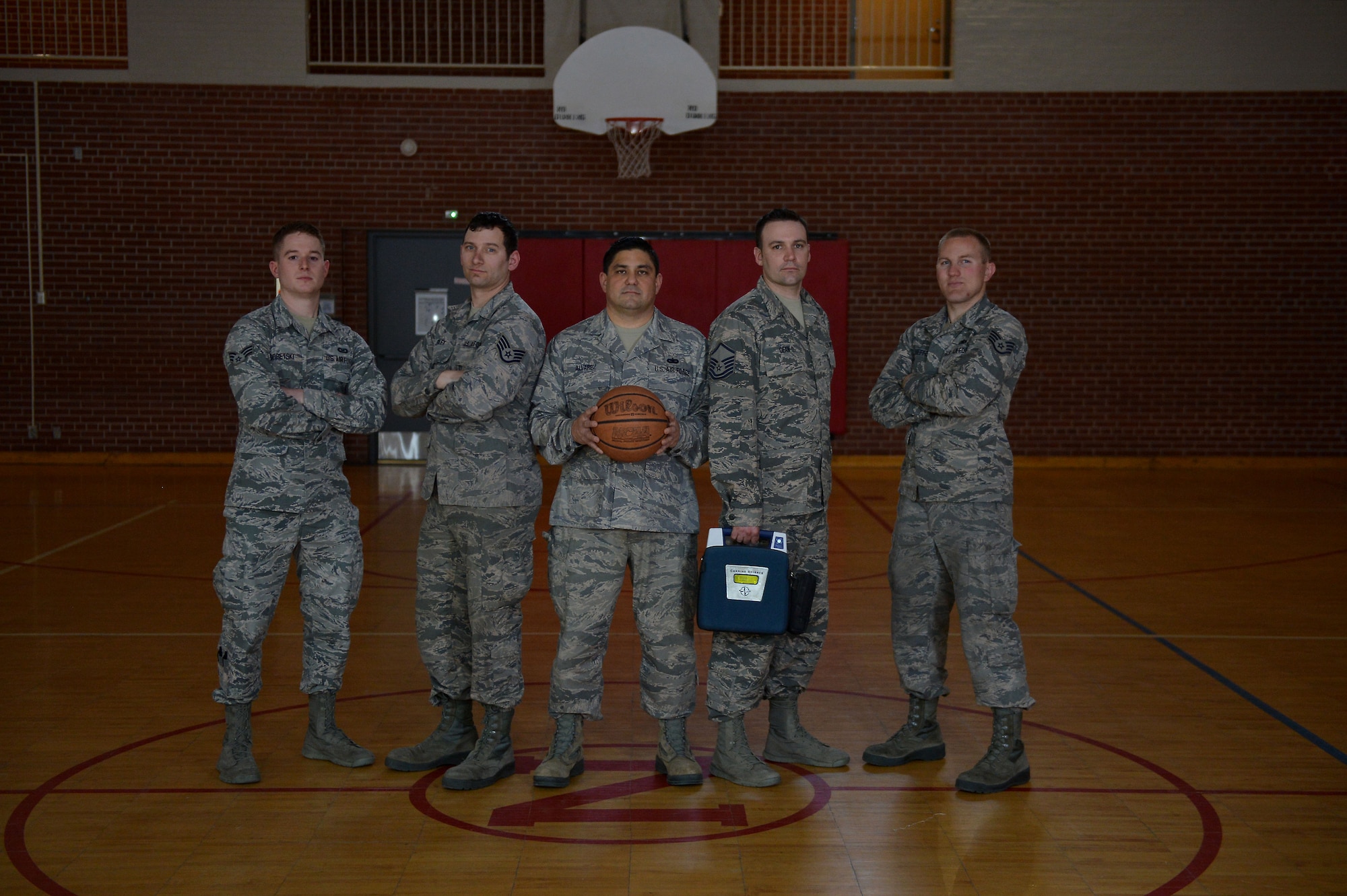 Senior Airman Jonathan Sobetski, Staff Sgt. Matthew Riley, Tech. Sgt. Michael Alvarez, Master Sgt. Jeremy Dean and Staff Sgt. Dan Schieffer pose on the basketball court right where the incident happened, April 17, 2018, at the Spirit of '76 Armory Lincoln, Nebraska. 
(U.S. Air Force photo taken by Senior Master Sgt. Shannon Nielsen/Released)