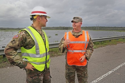 U.S. Army Corps of Engineers, Charleston District Commander, Lt. Col. Jeffrey Palazzini, left, coordinates flood mitigations efforts underway along U.S. Highway 501 in Horry County, S.C., with South Carolina Army National Guard Lt. Col. William A. Matheny, commander, 122 Engineering Battalion, Sept. 16, 2018. Army National Guard engineering units are working here with U.S. Army Corps of Engineers logistics and technical experts in support of FEMA, state and local partners during post-storm recovery operations.