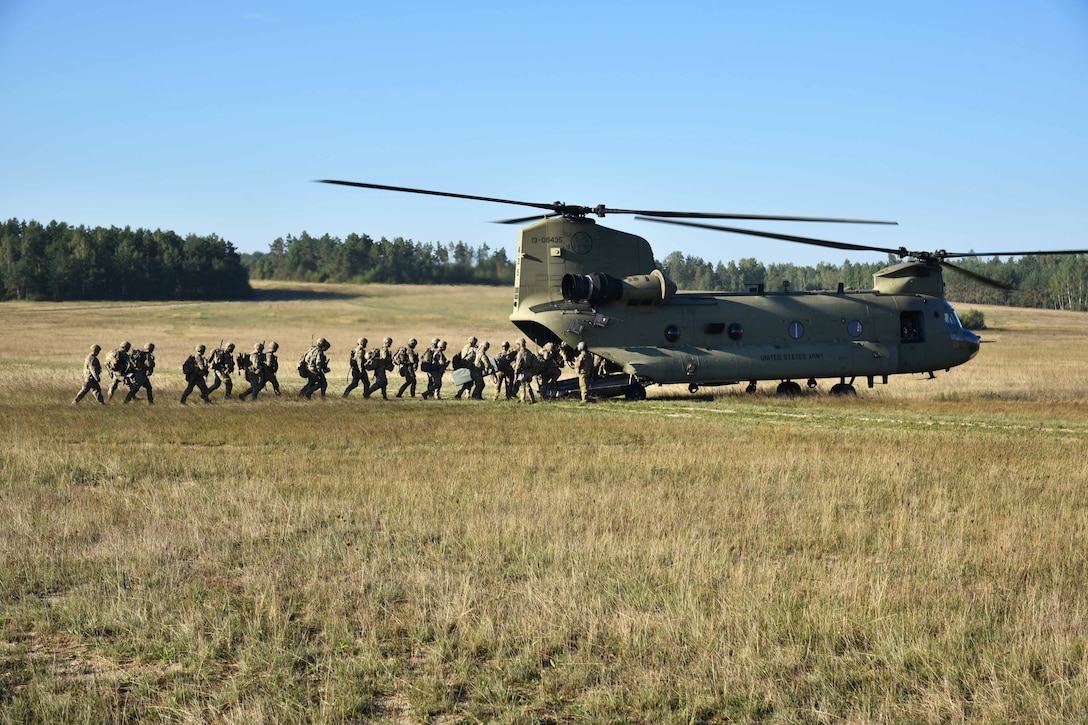 Soldiers upload onto a CH-47 Chinook helicopter after completing air assault training.