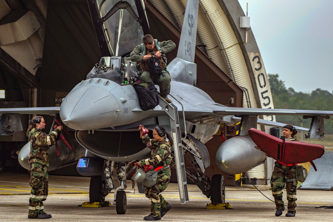 Capt. Timothy Neely, 480th Fighter Squadron pilot, dismounts from an F-16 Fighting Falcon at Spangdahlem Air Base, Germany, Sept. 13, 2018, during a base-wide readiness exercise. Exercises help ensure 52nd Fighter Wing aircraft have the ability to continue flying during an attack and can respond to any regional threat in a moment's notice. (U.S. Air Force photo by Airman 1st Class Valerie Seelye)