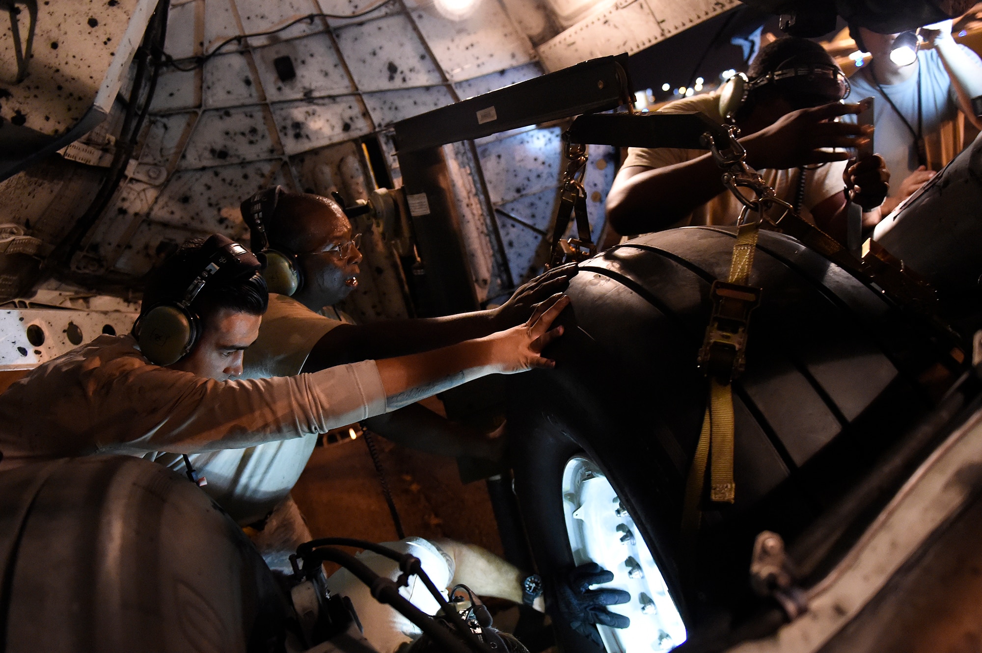 Airmen assigned to the 437th Aircraft Maintenance Squadron change a tire on a C-17 Globemaster III Sept. 13, 2018, at Scott Air Force Base, Ill. 437th AMXS maintainers serviced more than 10 aircraft that were evacuated from Joint Base Charleston, S.C., to Scott AFB ahead of Hurricane Florence. In all, more than 20 C-17s and supporting personnel were evacuated to designated safe locations, enabling them to continue their global airlift operations. (U.S. Air Force Courtesy photo)