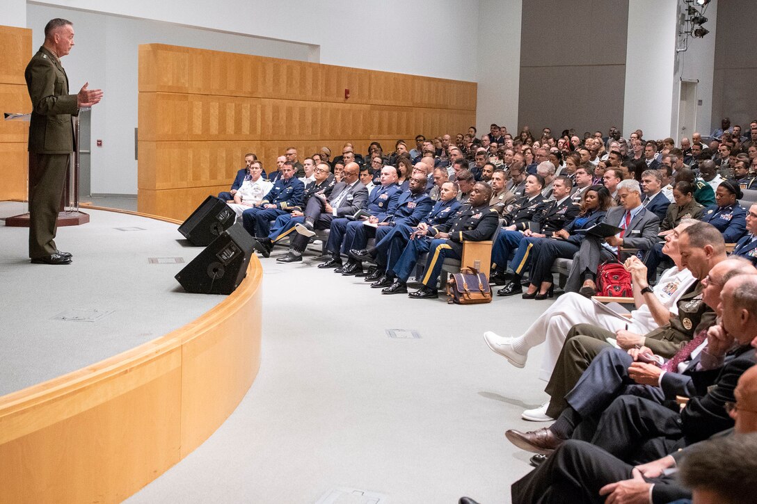 Marine Corps Gen. Joe Dunford, chairman of the Joint Chiefs of Staff, stands on a stage while making remarks.