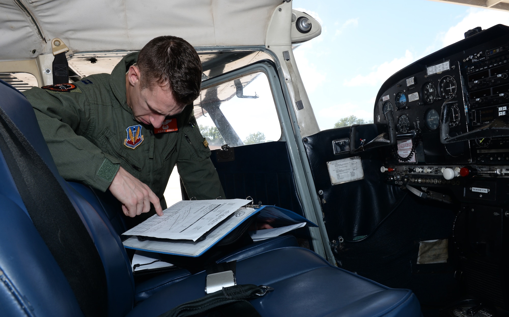 U.S. Air Force Capt. Adam Sema, 338th Combat Training Squadron student pilot, reviews the takeoff data sheet of a Cessna 172F aircraft Sept. 14, 2018, at the LeMay Aero Club on Offutt Air Force Base, Nebraska. The club offers in person group study as well as assisting participants with online course work to become certified pilots. (U.S. Air Force photo by Charles J. Haymond)