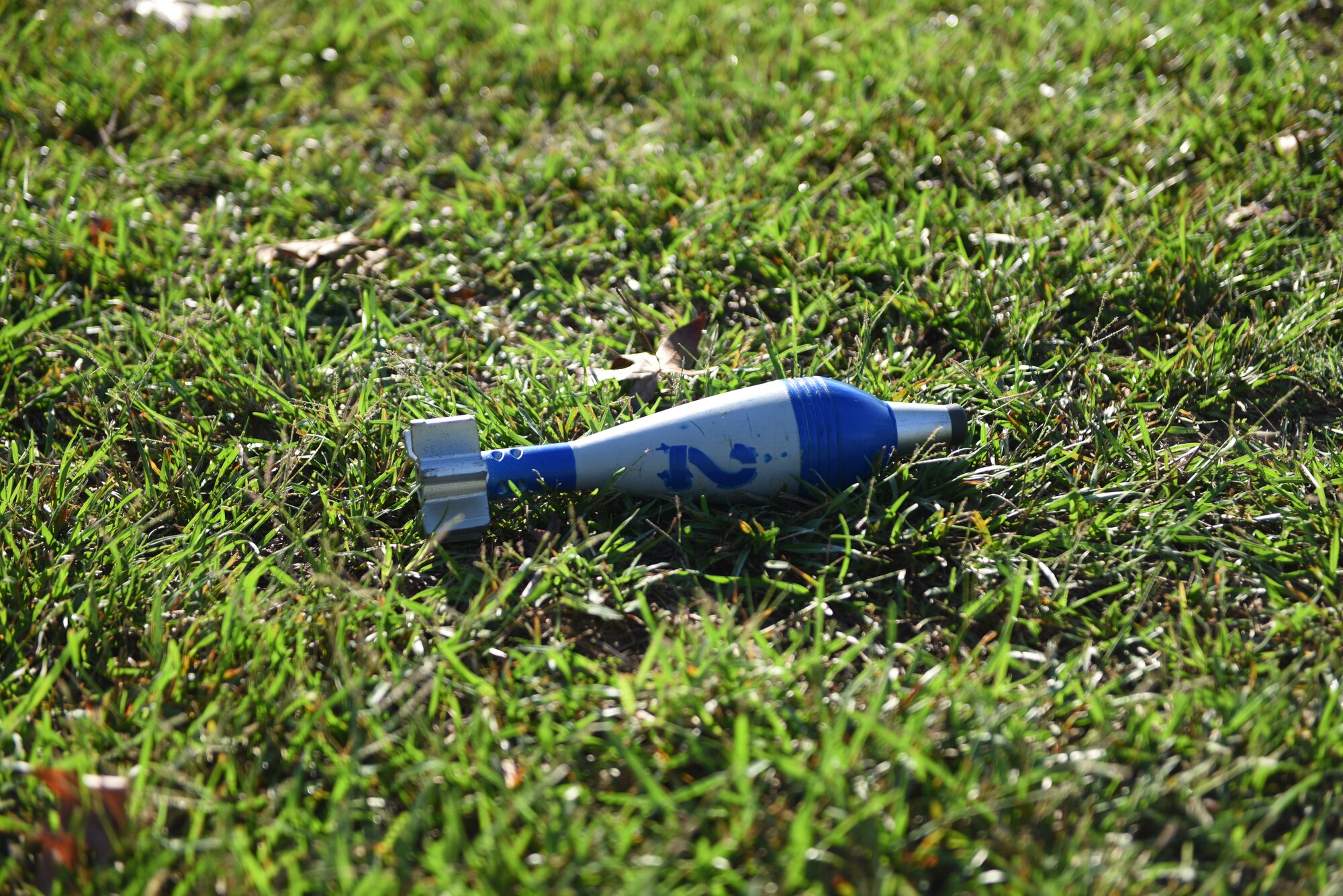 A simulated unexploded ordinance sits in the grass during an Operational Readiness Exercise: Ability To Survive and Operate course Sept. 19, 2018, on Columbus Air Force Base, Mississippi. Along with teaching Airmen how to identify chemical, biological, radioactive or nuclear contaminants, ATSO also teaches how to avoid UXOs while checking for CBRN contamination. (U.S. Air Force photo by Airman 1st Class Beaux Hebert)