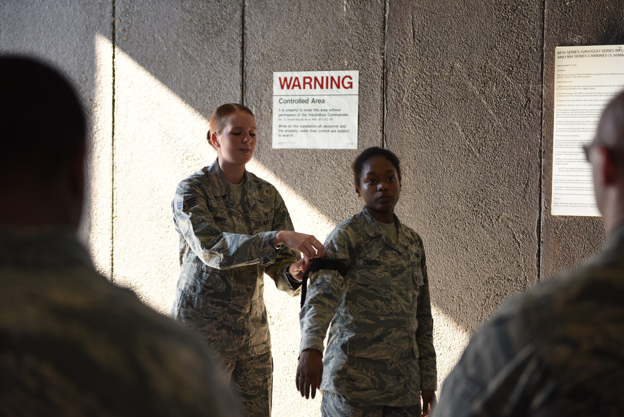 Senior Airman Gabrielle Achuff, 14th Medical Operation Squadron Aerospace and Operation Physiology Flight technician, shows how to properly use a tourniquet on Senior Airman Kelsey Ganter, 37th Flying Training Squadron Aviation Resource Management technician, Sept. 19, 2018, on Columbus Air Force Base, Mississippi. The demonstration was part of Operational Readiness Exercise: Ability to Survive and Operate course. ATSO training teaches Airmen how to use self-aid and buddy care techniques that could potentially save the life of a casualty. (U.S. Air Force photo by Airman 1st Class Beaux Hebert)