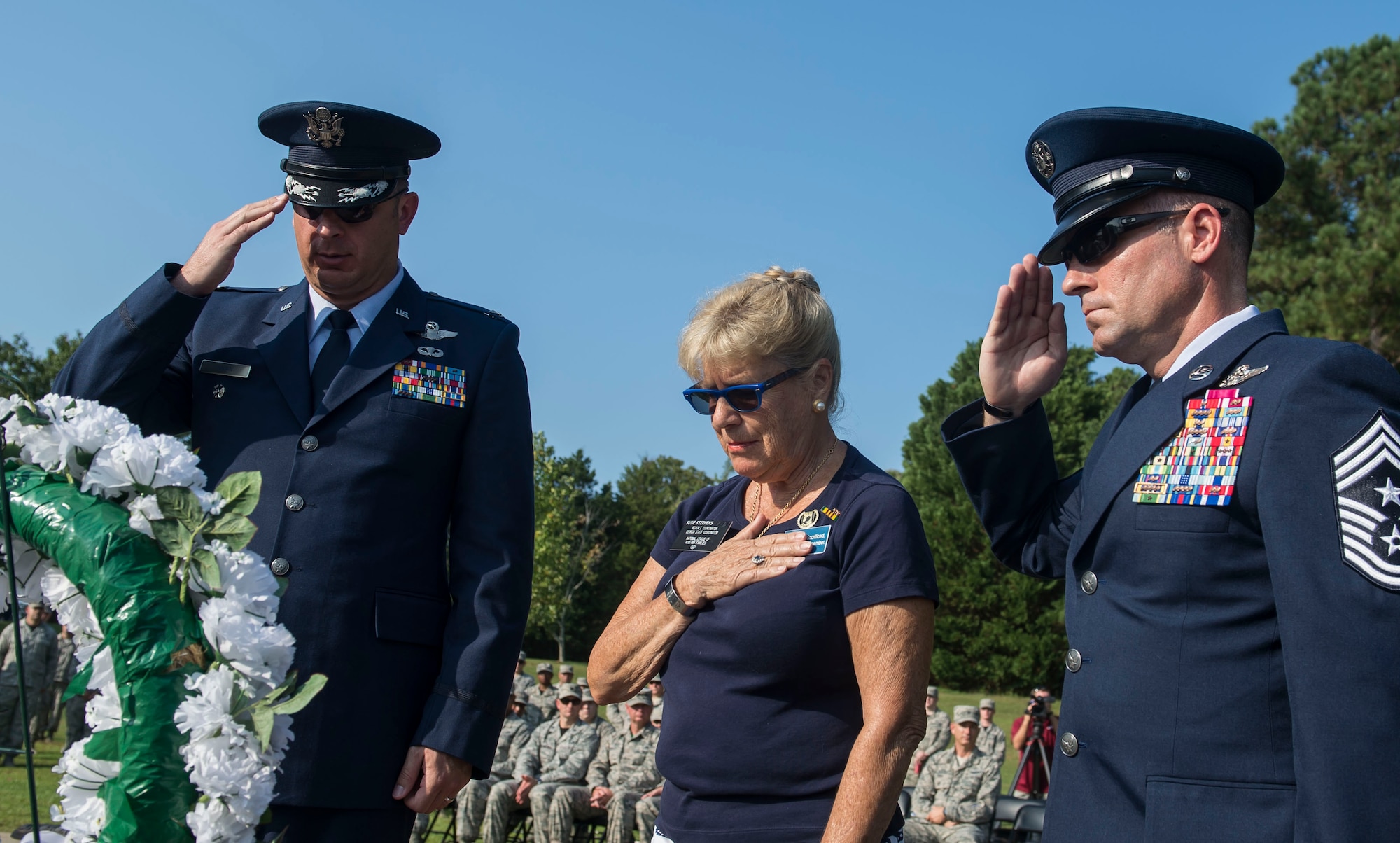 From left, U.S. Air Force Col. Ryan Inman, 20th Fighter Wing (FW) vice commander, Susan Stephens, POW/MIA ceremony guest speaker, and Chief Master Sgt. Daniel Hoglund, 20th FW command chief, render honors during a ceremony at Shaw Air Force Base, S.C., Sept. 21, 2018.