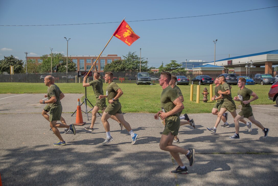 Marines from Charlie Co., Fleet Anti-terrorism Security Team, U.S. Marine Corps Security Forces Regiment finish a 5K run/Walk event as part of the Marine Corps Community Services 2018 Resource and Health Fair near Naval Support Activity Hampton Roads, Sept. 21. Marines were joined by other service members and their families to help promote physical fitness and healthy lifestyle. (Official U.S. Marine Corps photo by Chris Jones/Released)