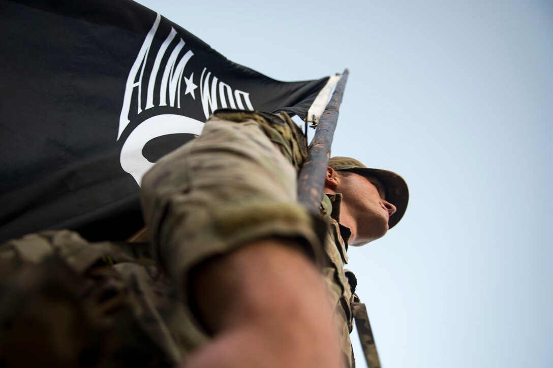 Senior Airman Matthew Vickers, 820th Combat Operations Squadron unit trainer, carries a guidon during the POW/MIA Recognition Day ruck march, Sept. 21, 2018, at Moody Air Force Base, Ga. For the first-time, the 347th Operations Support Squadron hosted a ruck march to pay tribute to those who’ve been captured or missing in the line of duty by carrying a POW/MIA flag for 24 hours. (U.S. Air Force photo by Airman 1st Class Erick Requadt)