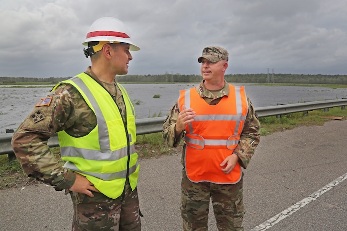 U.S. Army Corps of Engineers, Charleston District Commander, Lt. Col. Jeffrey Palazzini (left), coordinates flood mitigations efforts underway along U.S. Highway 501 in Horry County, S.C., following impact of Hurricane Florence with South Carolina Army National Guard Lt. Col. William A. Matheny, commander, 122 Engineering Battalion, Sept. 16, 2018.