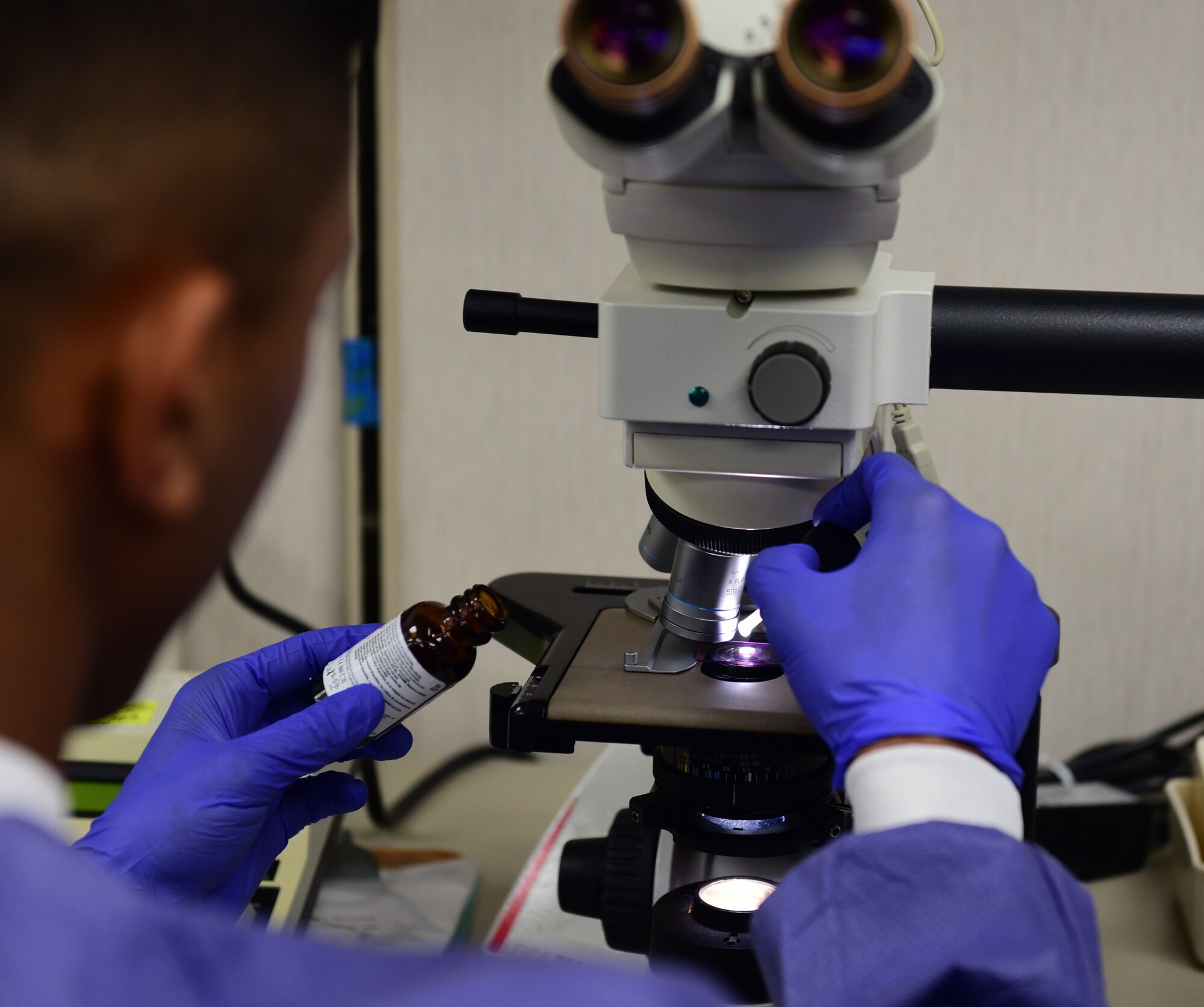 U.S. Air Force Staff Sgt. Jadow Hughes, 325th Medical Support Squadron laboratory technician, prepares to use a microscope to inspect a blood sample at Tyndall Air Force Base, Fla., Sept. 5, 2018. Helping conduct essential tests on body substances, medical laboratory specialists have an integral role in providing patients with a proper diagnosis and treatment. (U.S. Air Force photo by Senior Airman Cody R. Miller)