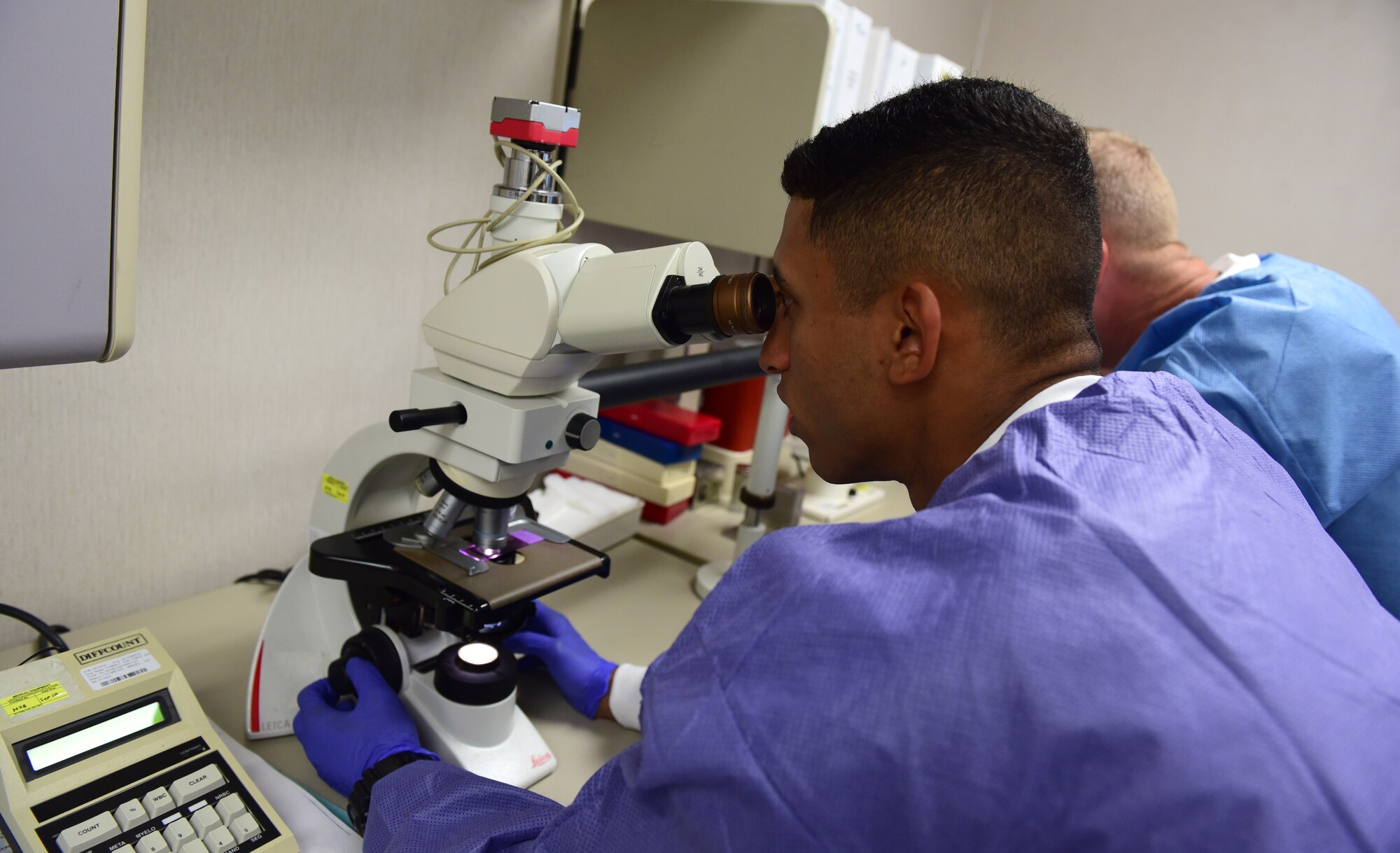 U.S. Air Force Staff Sgt. Jadow Hughes, 325th Medical Support Squadron laboratory technician, shows Col. Brian Laidlaw, 325th Fighter Wing commander how blood samples look under a microscope at Tyndall Air Force Base, Fla., Sept. 5, 2018. Medical laboratory specialists conduct state-of-the-art analysis that not only helps prevent and treat disease, but is essential to detecting agents that indicate biological warfare. (U.S. Air Force photo by Senior Airman Cody R. Miller)