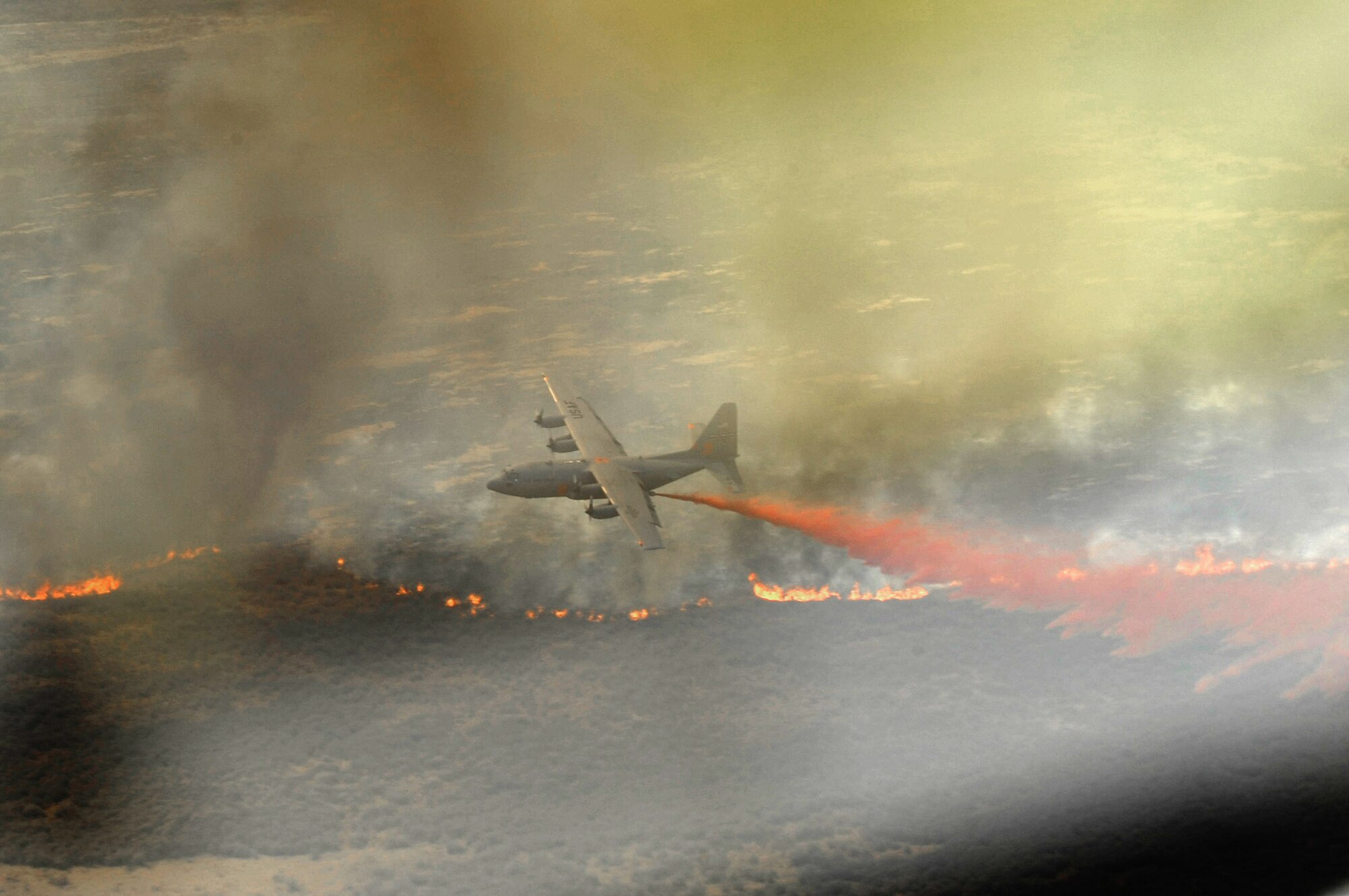 A Modular Airborne Fire Fighting System-equipped C-130 Hercules aircraft assigned to the Air Force Reserve Command’s 302nd Airlift Wing, drops fire retardant April 27, 2011, above West Texas. The MAFFS is capable of dispensing 3,000 gallons of water or fire retardant in less than 5 seconds. (U.S. Air Force photo by Staff Sgt. Eric Harris)
