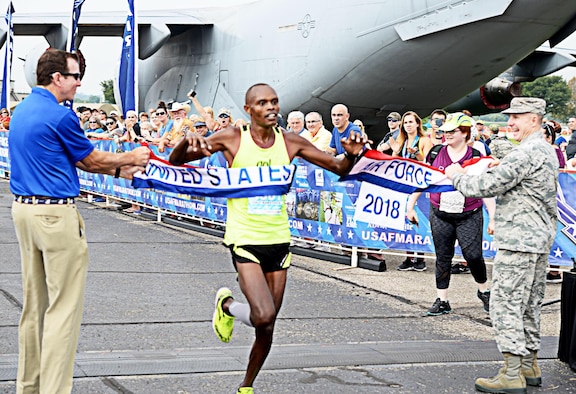 U.S. Air Force Airman 1st Class Daniel Kirwa, an aerospace medical technician assigned to the 6th Medical Operations Support Squadron, crosses the finish line in first place during the Air Force half marathon race held at Wright-Patterson Air Force Base, Ohio, Sept. 15, 2018. Kirwa finished with a time of 1:12:05, which is a 5:32 pace for 13 miles.
