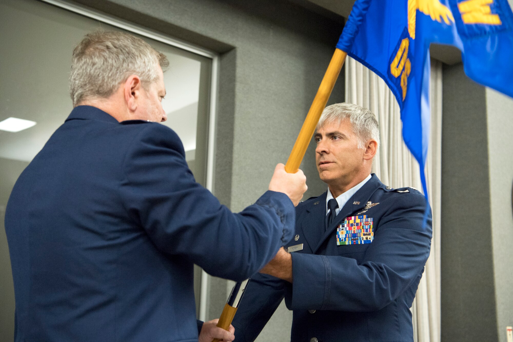 Lt. Col. Douglas Perry, right, 434th Operations Support Squadron commander, takes the 434th OSS guidon from Col. Brian Hollis, 434th Operations Group commander, during an assumption of command ceremony at Grissom Air Reserve Base, Ind., Sept. 8, 2018.  The main mission of the 434th OSS is to support the 434th Air Refueling Wing combat-ready KC-135 Stratotanker aircrews. (U.S. Air Force photo by Tech. Sgt. Ben Mota)