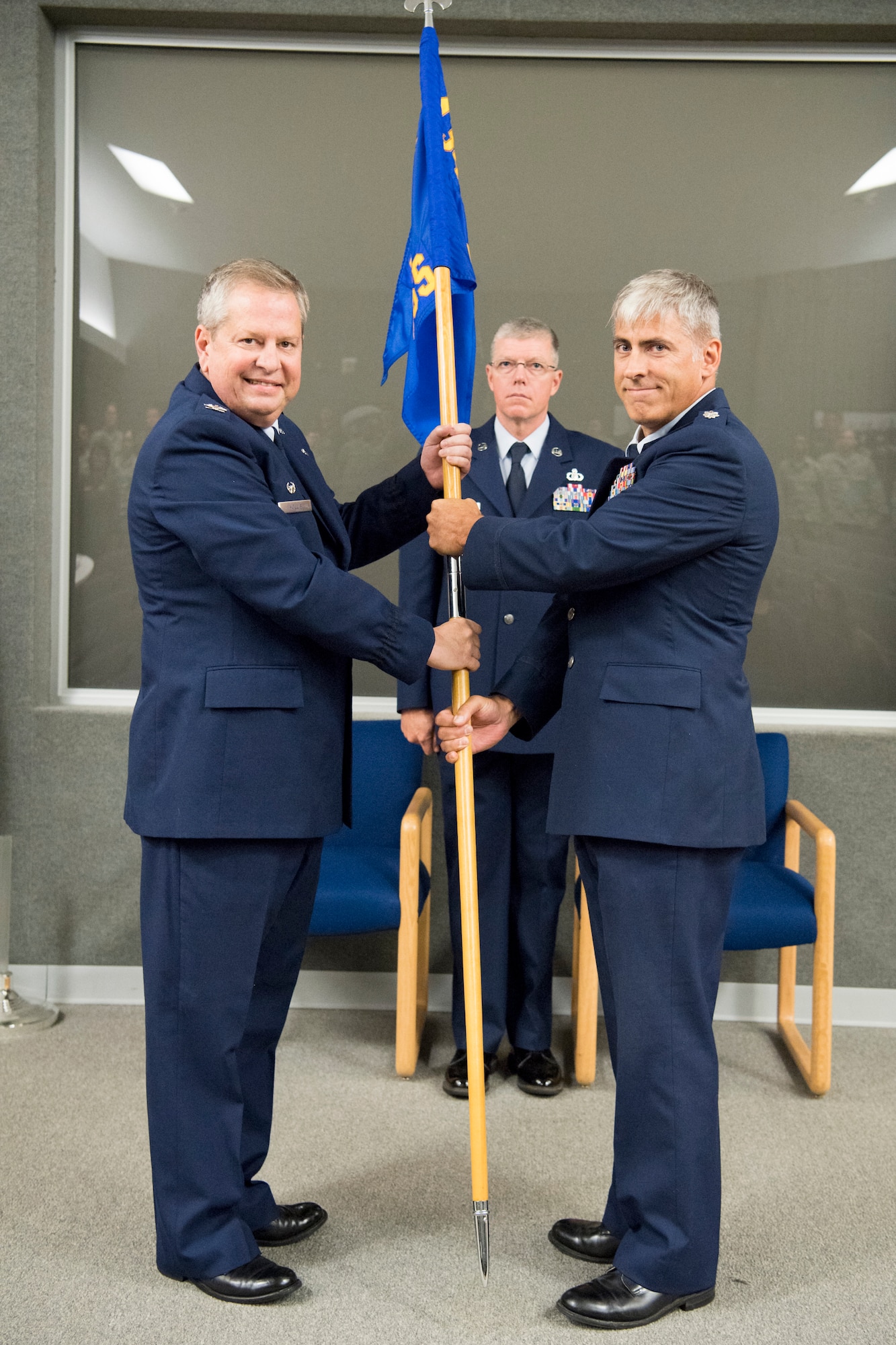 Lt. Col. Douglas Perry, right, 434th Operations Support Squadron commander, and Col. Brian Hollis, 434th Operations Group commander, pose with the 434th OSS guidon during an assumption of command ceremony at Grissom Air Reserve Base, Ind., Sept. 8, 2018.  The main mission of the 434th OSS is to support the 434th Air Refueling Wing combat-ready KC-135 Stratotanker aircrews. (U.S. Air Force photo by Tech. Sgt. Ben Mota)