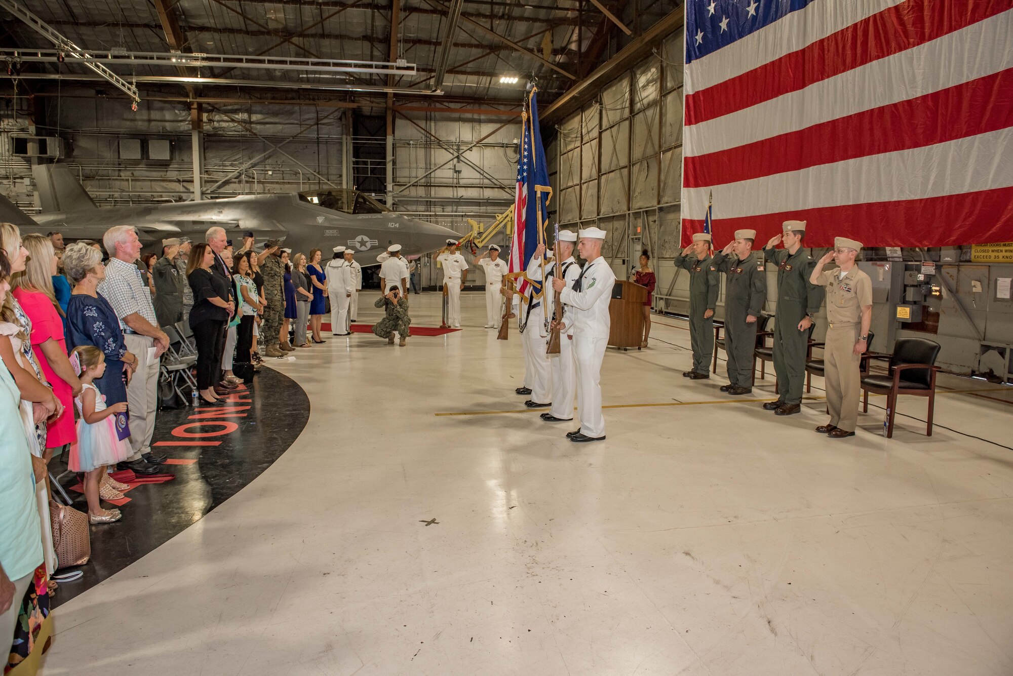 Commander Ernest Anderson, VX-9 DET Edwards commander (left), is greeting by Command Master Chief Petty Officer Ronnie Ogren, VX-9 DET Edwards' senior enlisted member, before a change of command ceremony in Hangar 1810 Sept. 20. Anderson assumed command of the U.S. Navy's local F-35C test unit. (U.S. Air Force photo by Matt Williams)