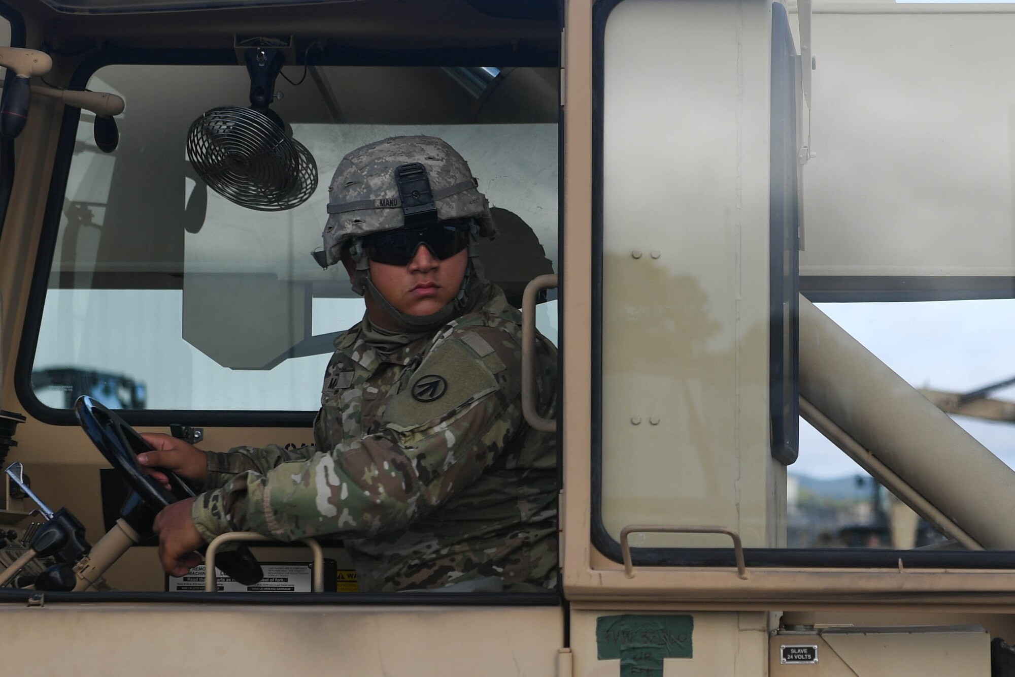 U.S. Army Spc. Kyler Mano, 689th Rapid Port Opening Element, 832nd Transportation Battalion, 597th Transportation Brigade cargo specialist, waits to move cargo pallets during Exercise Turbo Distribution 18-02 at Fort McCoy, Wisconsin, Sept. 9, 2018. The 689th RPOE's mission set requires the unit to be deployable within 12 hours of notification anywhere in the world. (U.S. Air Force photo by Senior Airman Derek Seifert)