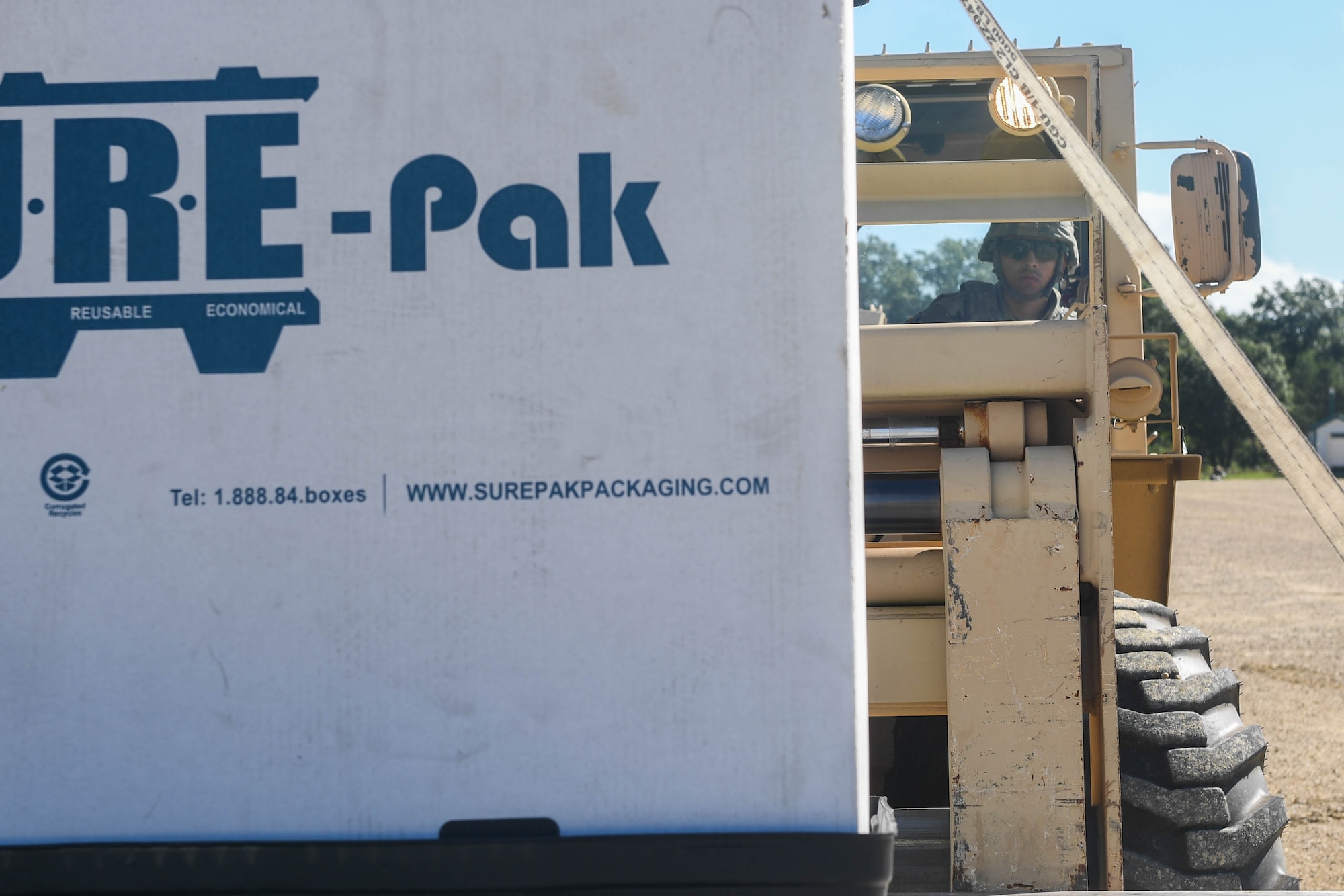 U.S. Army Pfc. Peter Jimenez, 689th Rapid Port Opening Element, 832nd Transportation Battalion, 597th Transportation Brigade cargo specialist, picks up a cargo pallet during Exercise Turbo Distribution 18-02 at Fort McCoy, Wisconsin, Sept. 9, 2018. Exercise Turbo Distribution 18-02 deployed the 689th RPOE and 821st Contingency Response Group to a simulated country to provide humanitarian aid for refugees fleeing from conflict. (U.S. Air Force photo by Senior Airman Derek Seifert)