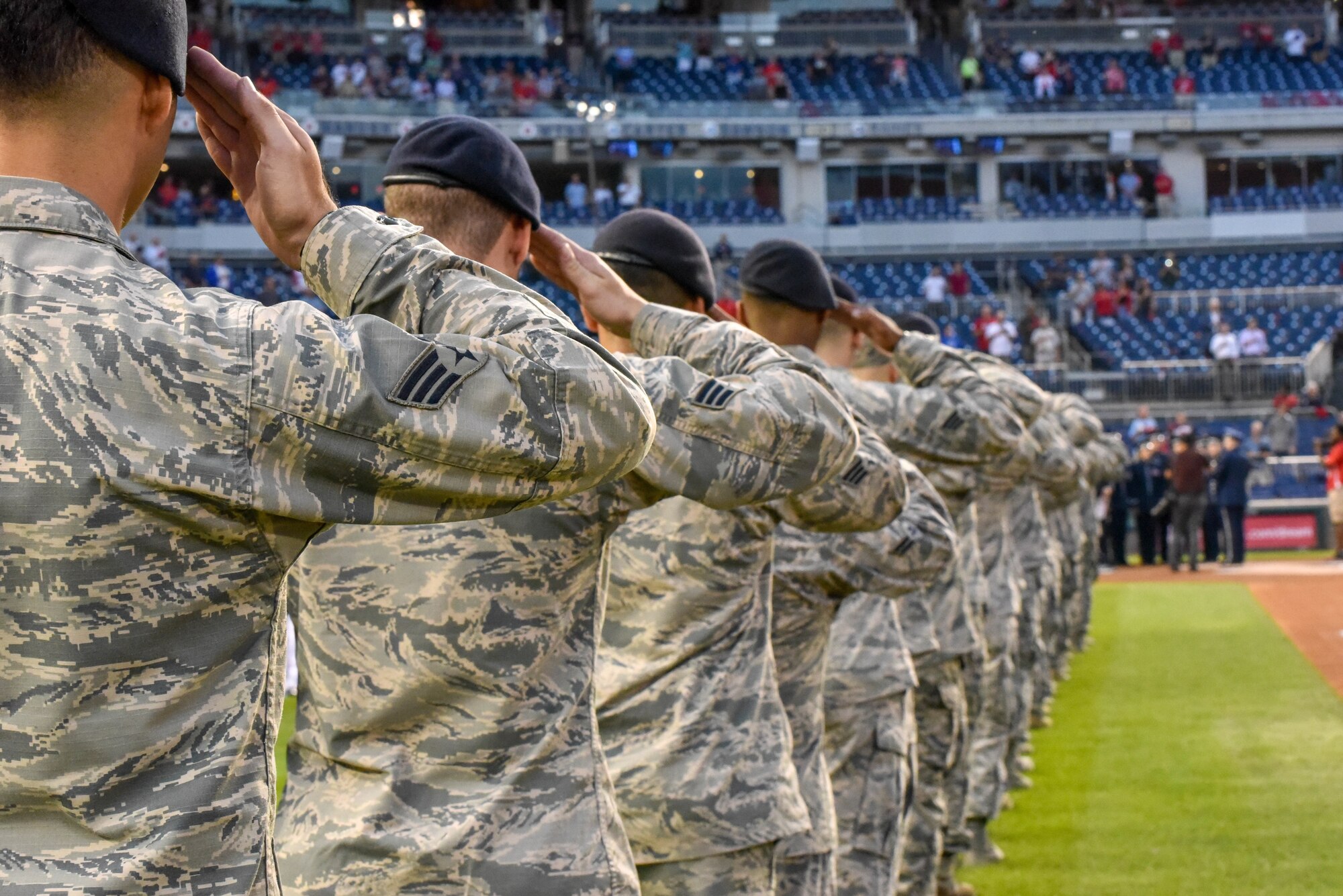 A line of Airmen salute.
