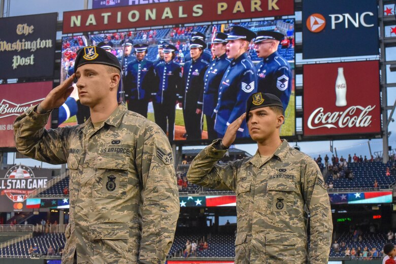 Two Airmen salute.