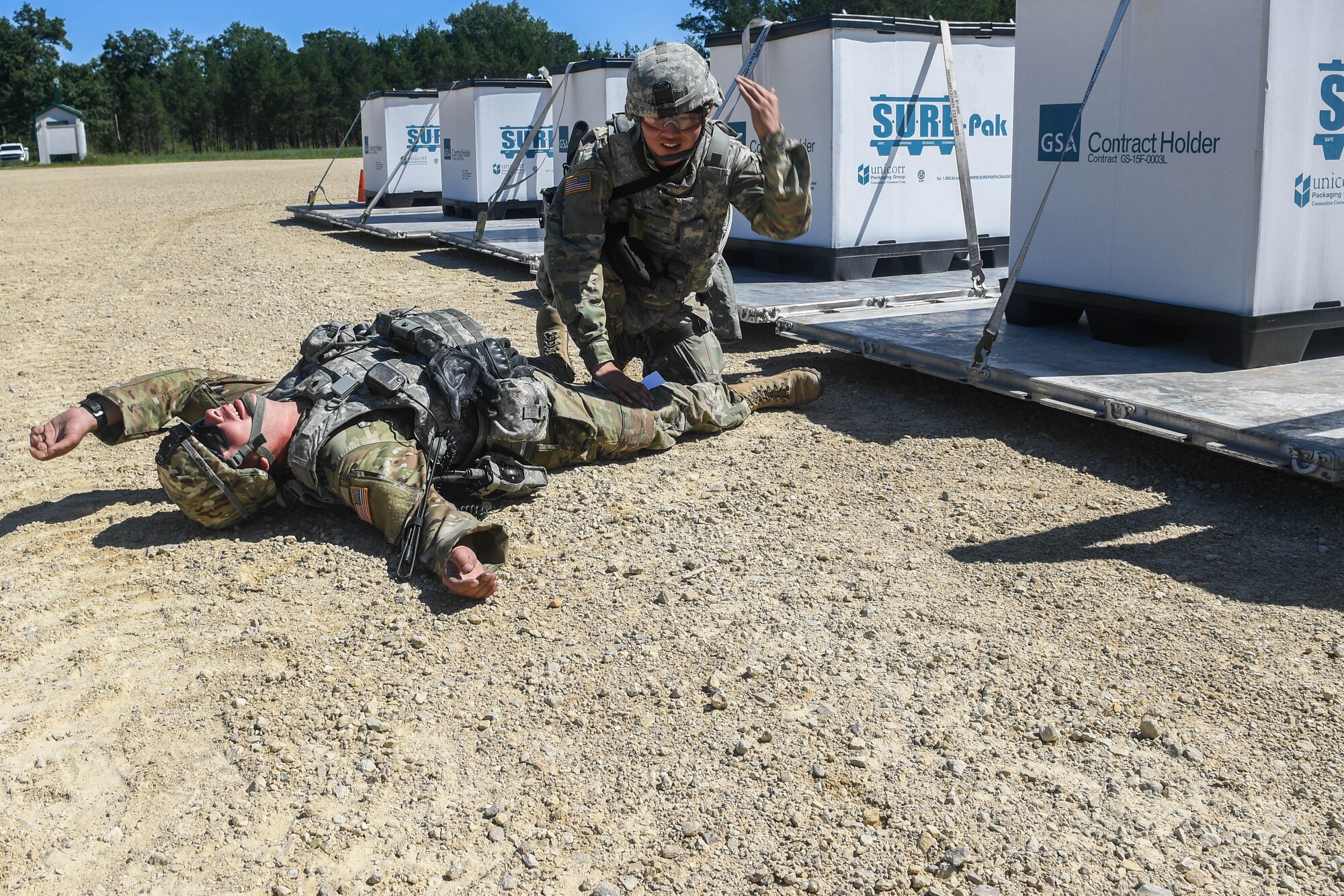 U.S. Army Spc. Hyeongmin Lee, 689th Rapid Port Opening Element, 832nd Transportation Battalion, 597th Transportation Brigade cargo specialist, requests medical assistance after a simulated injury during Exercise Turbo Distribution 18-02 at Fort McCoy, Wisconsin, Sept. 9, 2018. The 689th RPOE was tested with several scenarios on how the unit would respond to a simulated injury, chemical attack or disease outbreak in the area. (U.S. Air Force photo by Senior Airman Derek Seifert)