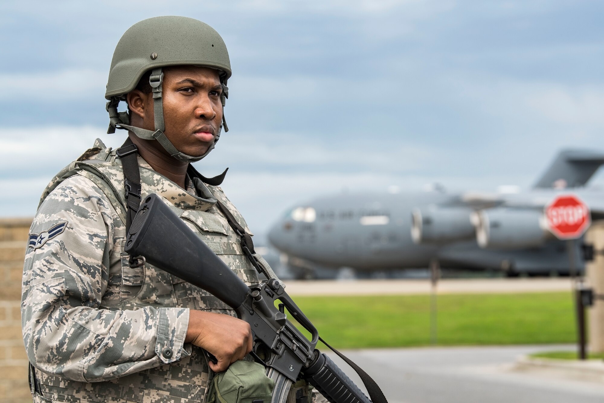 Airman 1st Class Denzel Gills, 9th Airlift Squadron aviation research management journeyman, stands guard near a flight line vehicle access gate Sept. 17, 2018, on Dover Air Force Base, Del. Gills was one of 34 Integrated Base Defense certified individuals who provided security for personnel and base assets during a two-day Force Protection/Major Accident Response Exercise. (U.S. Air Force photo by Roland Balik)
