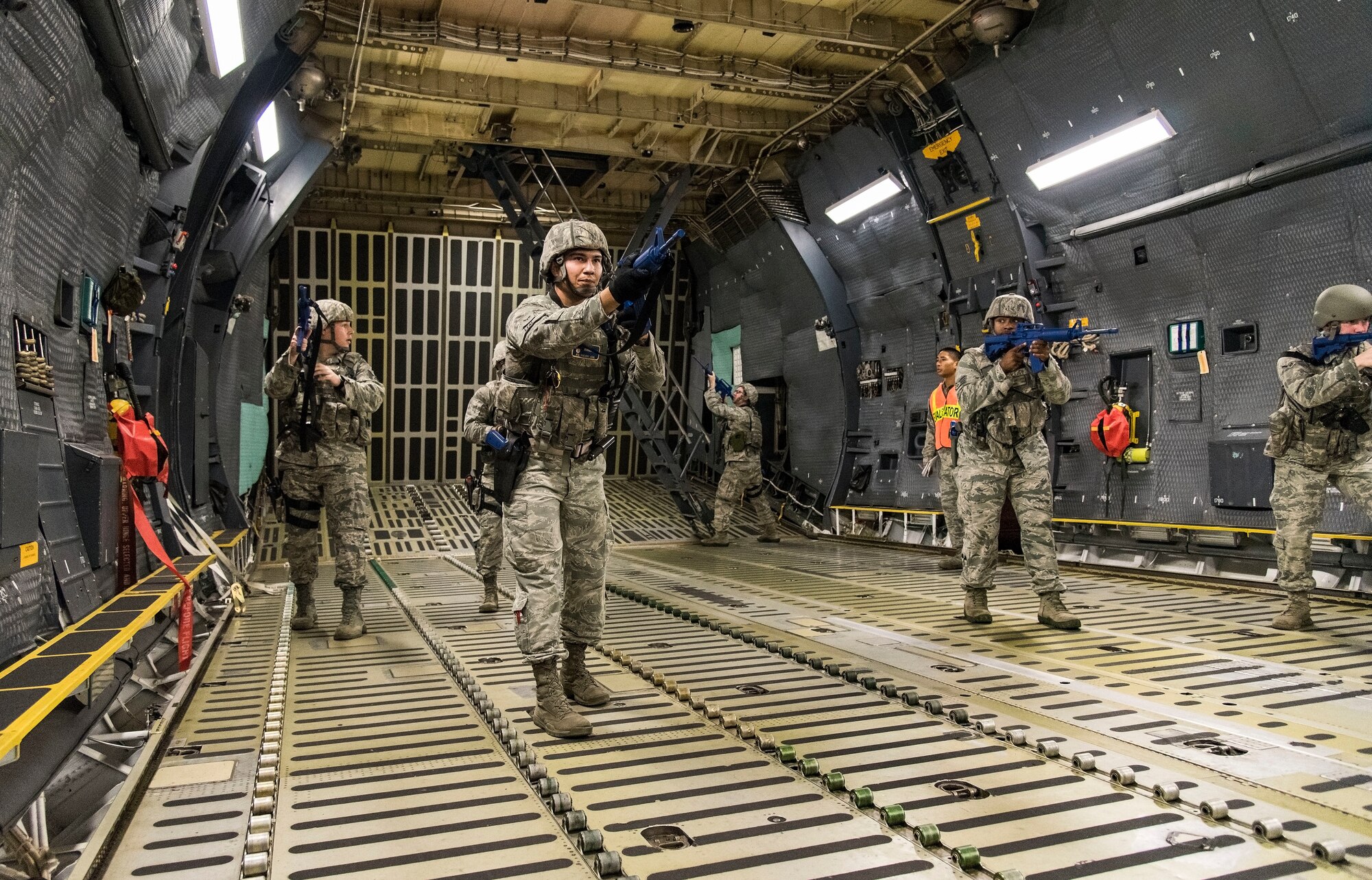 A 436th Security Forces Squadron response force team clears the C-5M Super Galaxy cargo compartment after entering the aircraft from a rear door Sept. 17, 2018, on Dover Air Force Base, Del. The response force team located and neutralized the mock hijacker who was holding mock hostages in the aircraft’s troop compartment. (U.S. Air Force photo by Roland Balik)