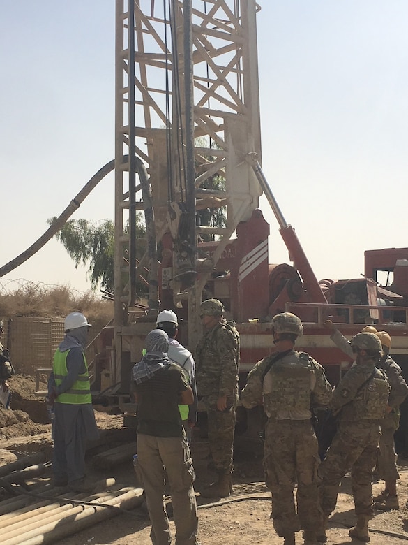 Project Engineer Brian Cagle, U. S. Army Corps of Engineers, Afghanistan District discusses the drilling operations and Quality Test procedures of a new Water Well with the contractors at the Kandahar Air Wing Waste & Water Treatment Project.