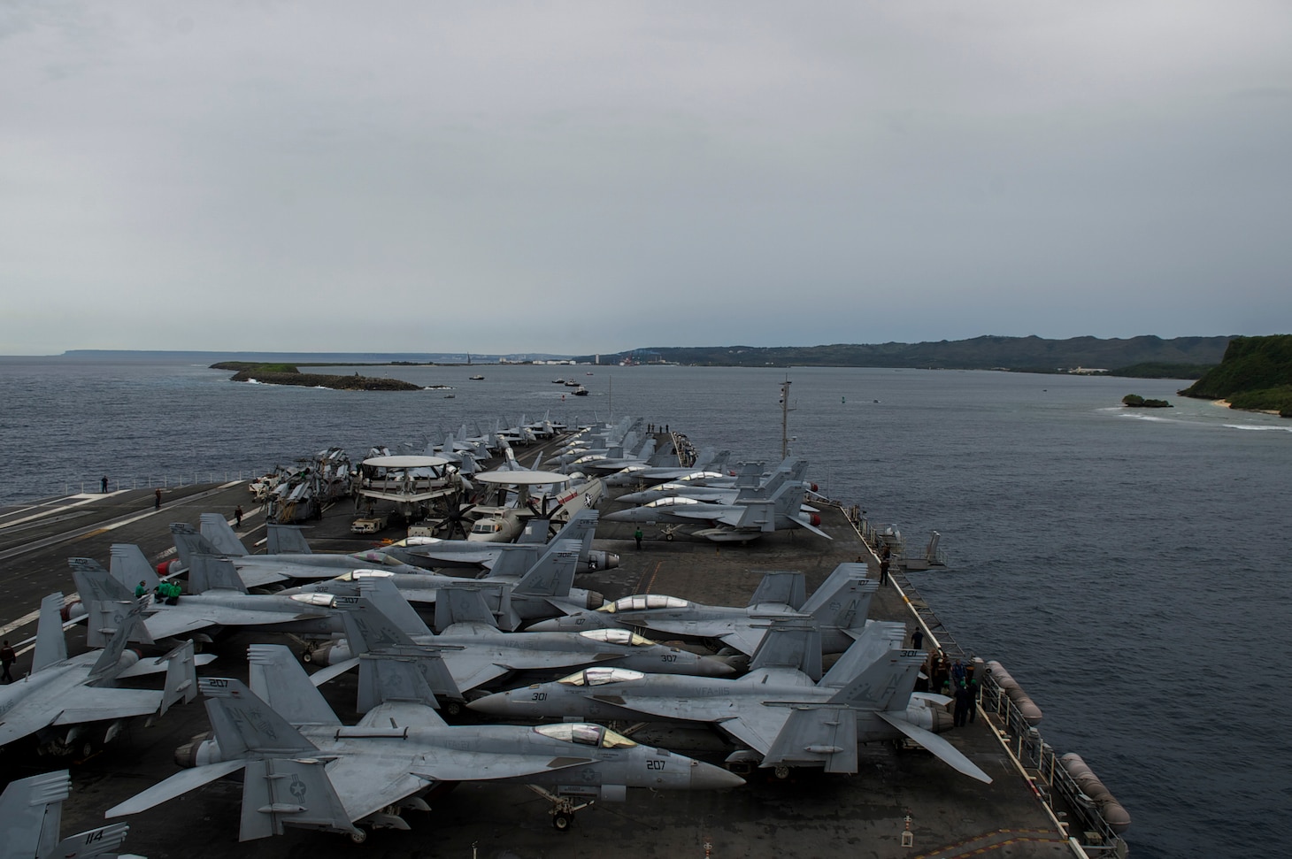 PHILIPPINE SEA (Sept. 17, 2018) The aircraft carrier USS Ronald Reagan (CVN 76) pulls into Apra Harbor, Guam after completing Valiant Shield 2018. The biennial, U.S. only, field-training exercise focuses on itegration of joint training among  the U.S. Navy, Air Force and Marine Corps. this is the seventh exercise in the Valiant Shield series that began in 2006.