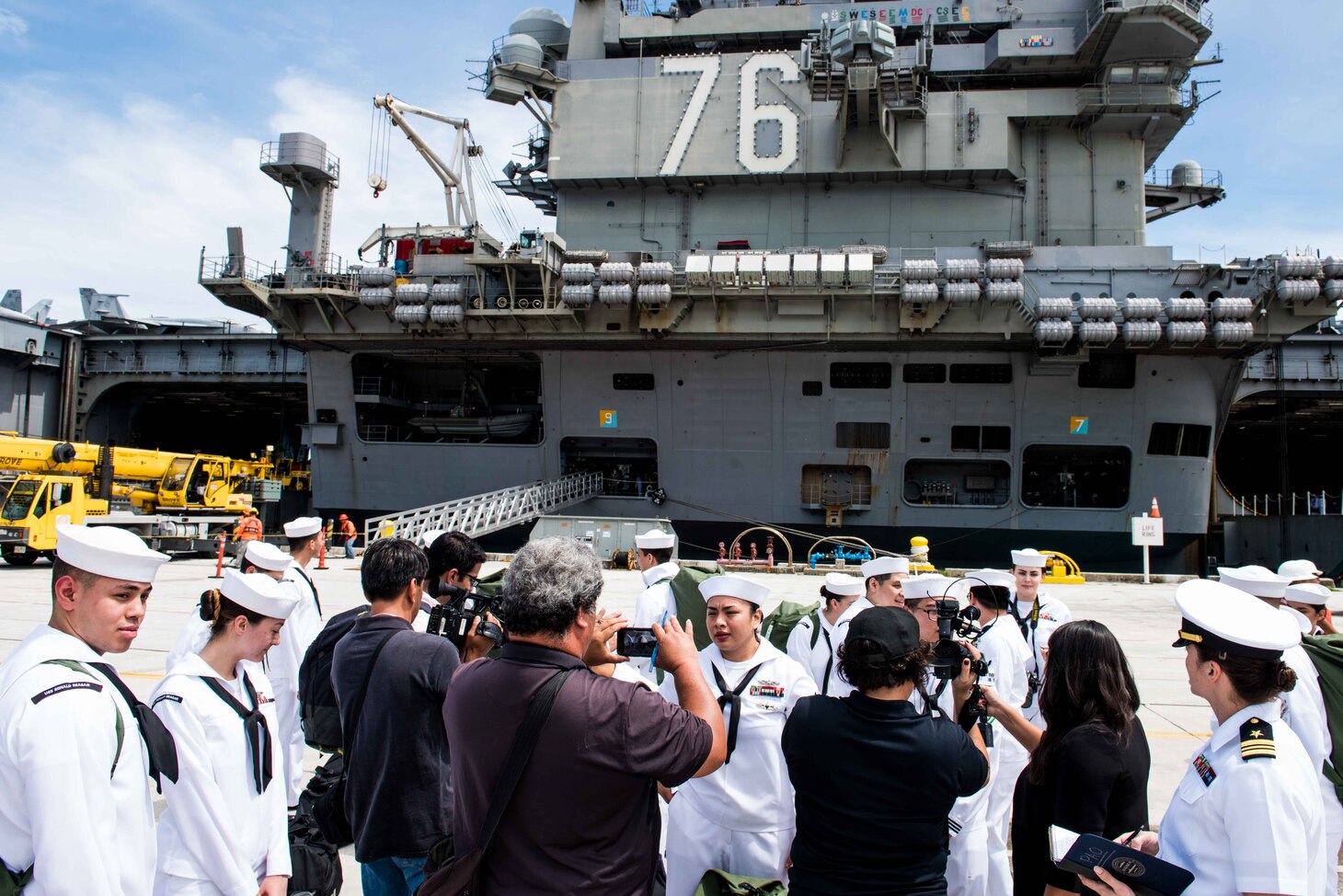 GUAM (September 24, 2018) Sailors from Guam speak with local media after the forward-deployed aircraft carrier USS Ronald Reagan (CVN 76) pulled into Guam for a port visit. Ronald Reagan provides a combat-ready force, which protects and defends the collective maritime interests of the U.S. and its allies and partners in the Indo-Pacific region.