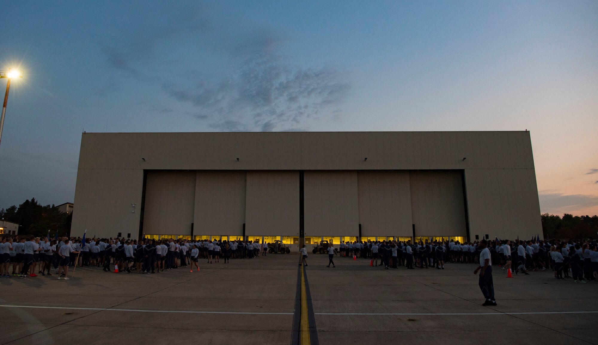 U.S. Airmen gather in front of a hanger on Ramstein Air Base, Germany, Sep 18, 2018, to listen to former prisoner of war U.S. Air Force Maj. Joe Crecca's experience during his time of captivity. After listening to Crecca's experience, U.S. Airmen took part in a 5K as part of the weeks events for Prisoner of War and Missing in Action Remembrance Week on Ramstein. (U.S. Air Force photo by Airman Kristof J. Rixmann)