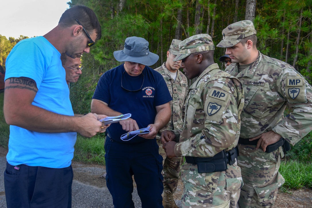 Marion County first responders show soldiers on a map where residents might be trapped and need evacuating.