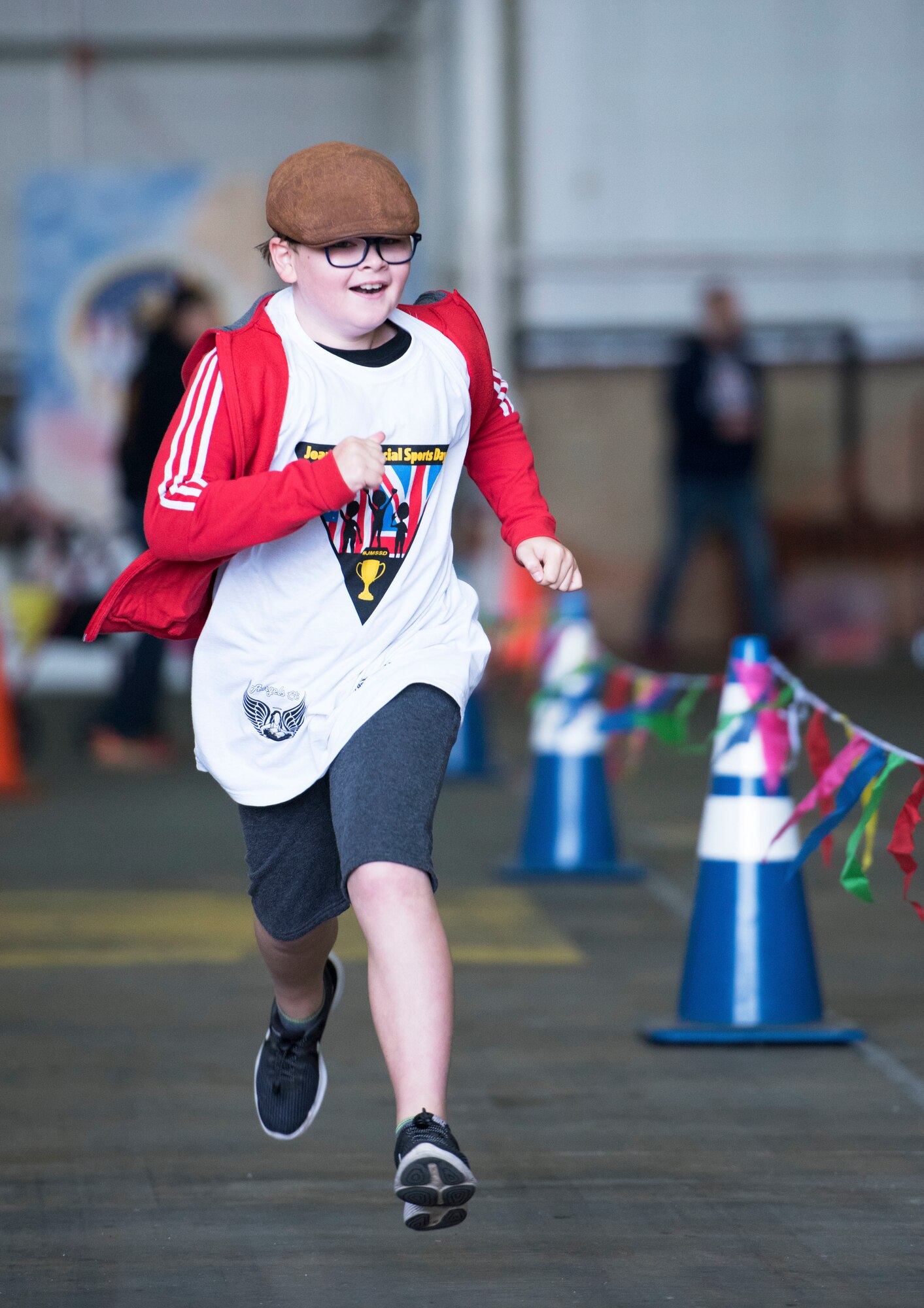 An athlete competes in the 100-yard run at the 37th Joan Mann Special Sports Day at RAF Mildenhall, England, Sept. 22, 2018.  The sporting event for special athletes included 12 different events, including the basketball shoot, obstacle course and football kick. (U.S. Air Force photo by Senior Airman Lexie West)