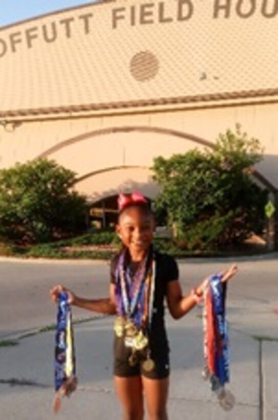 Jaiya Patillo, a Junior Olympian, poses for a photo outside the Offutt Field House on Offutt Air Force Base, Nebraska, 2018. After spending a considerable amount of time training at Offutt, Jaiya chose to represent the Air Force on her track apparel for Amateur Athletic Union track meets. (Courtesy Photo)