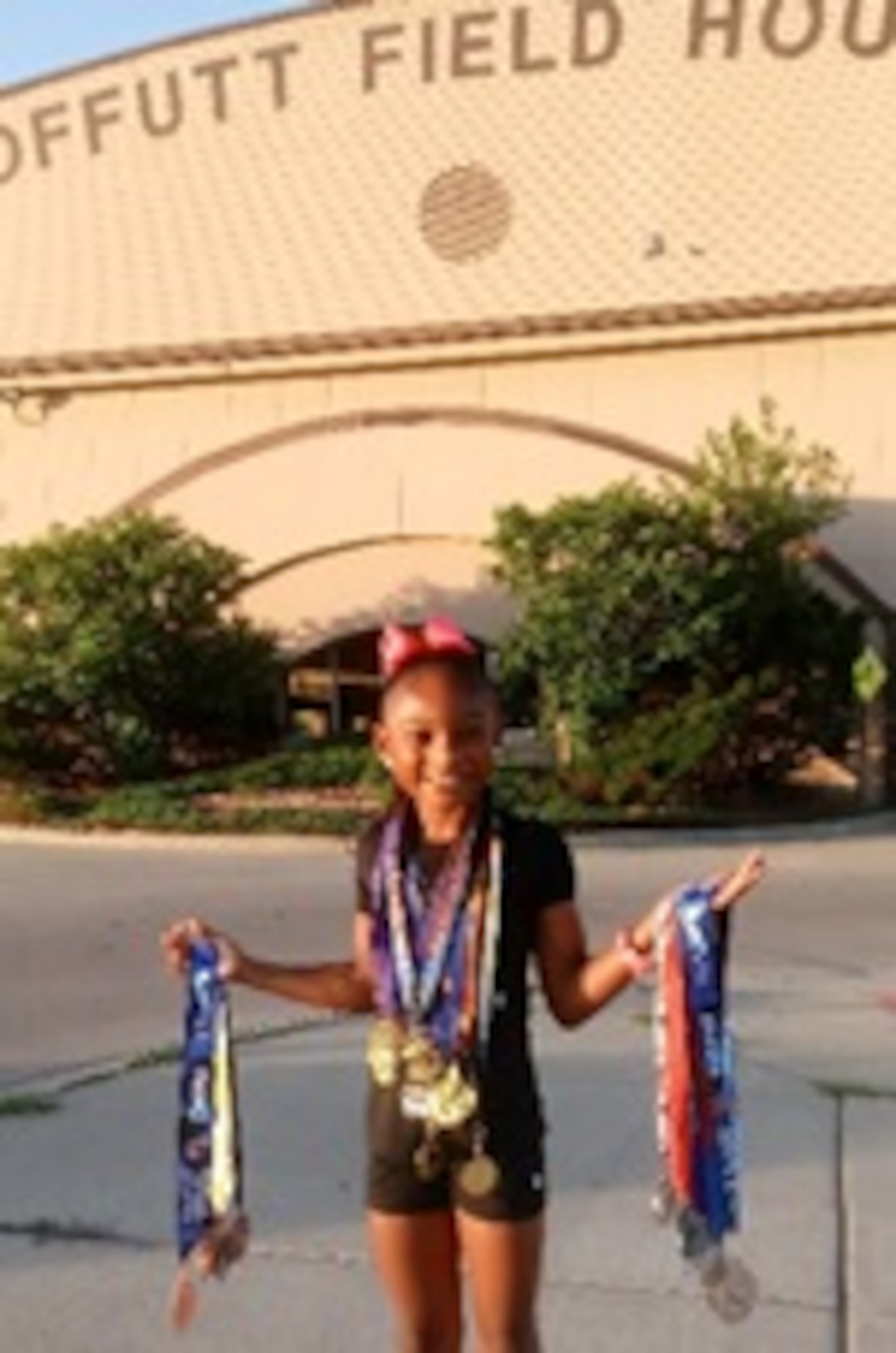 Jaiya Patillo, a Junior Olympian, poses for a photo outside the Offutt Field House on Offutt Air Force Base, Nebraska, 2018. After spending a considerable amount of time training at Offutt, Jaiya chose to represent the Air Force on her track apparel for Amateur Athletic Union track meets. (Courtesy Photo)