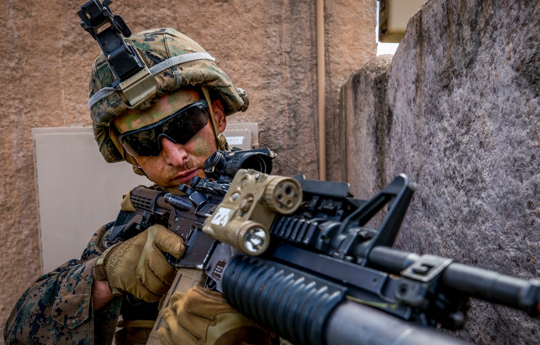 Lance Cpl. Michael Ziegenhals, a rifleman with India Company, 3rd Battalion, 3rd Marine Regiment, provides security during a village clearing drill part of a company level exercise at Marine Corps Training Area Bellows (MCTAB), Sept. 18, 2018. The company inserted into MCTAB with CH-53E Super Stallions to establish a secure landing zone, patrol over roads and through jungle terrain, and to clear simulated villages of hostiles.