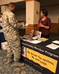 Valerie Barber, Joint Base San Antonio-Lackland Exceptional Family Member Program family support coordinator, hands out informational materials at a local resource fair.