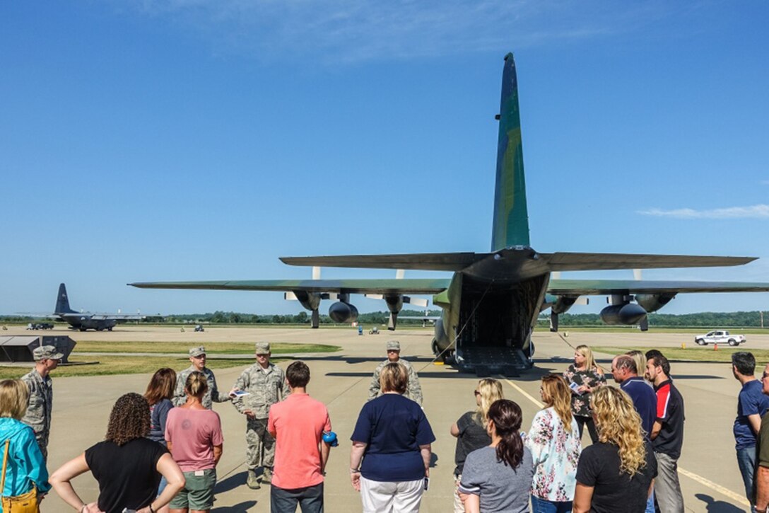 Soldiers tell people about aircraft on a runway.