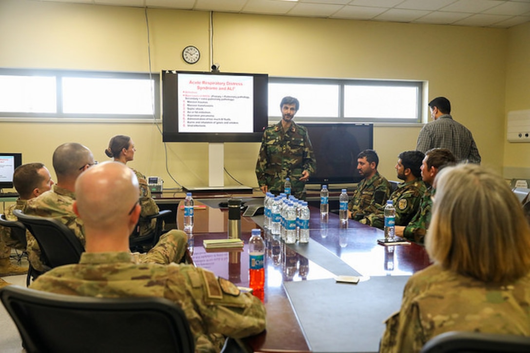 An Afghan medical officer with Kandahar Regional Military Hospital goes over a patient case study during a meeting between KRMH and NATO Role III Multinational Medical Unit medical staff at Kandahar Airfield, Afghanistan, Sept. 17, 2018. Army photo by Staff Sgt. Neysa Canfield