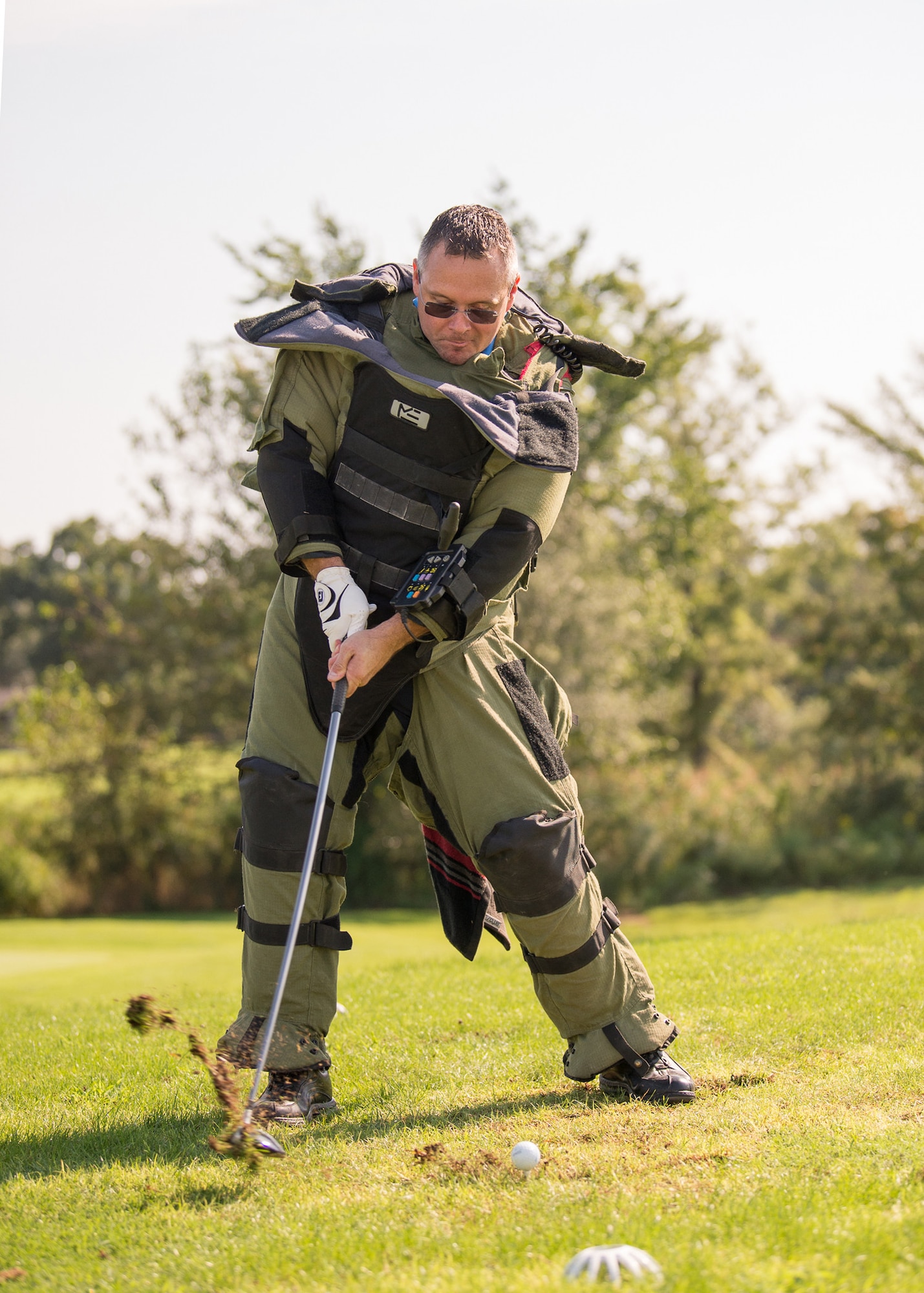 Lt. Col Jason Pennypacker, 512th Operations Group deputy commander, attempts to tee off while wearing an explosive ordnance disposal bomb suit at the Bluesuiters Golf Tournament Sept. 19, 2018, at the Eagle Creek Golf Course on Dover Air Force Base, Del. Teeing with the bomb suit was one of four special challenges set up throughout the 18-hole course.