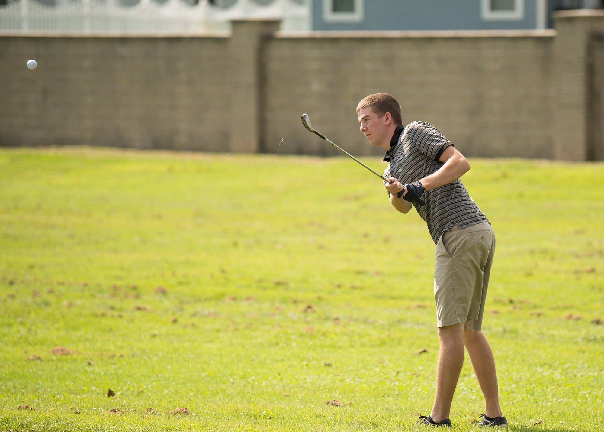Senior Airman Ryan Schenkelberg, 436th Maintenance Squadron C-5 isochronal crew chief, attempts to wedge a ball over a sand trap at the Bluesuiters Golf Tournament Sept. 19, 2018, at the Eagle Creek Golf Course on Dover Air Force Base, Del. Contestants were split into teams of four consisting of both military members and civilians.