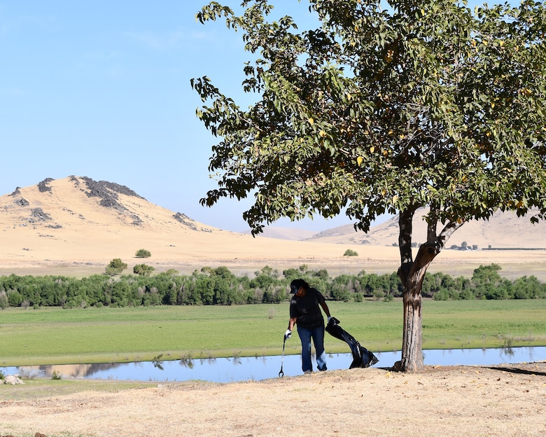 A volunteer picks up trash during a National Public Lands Day event held at the U.S. Army Corps of Engineers Sacramento District's Success Lake on September 22, 2018.