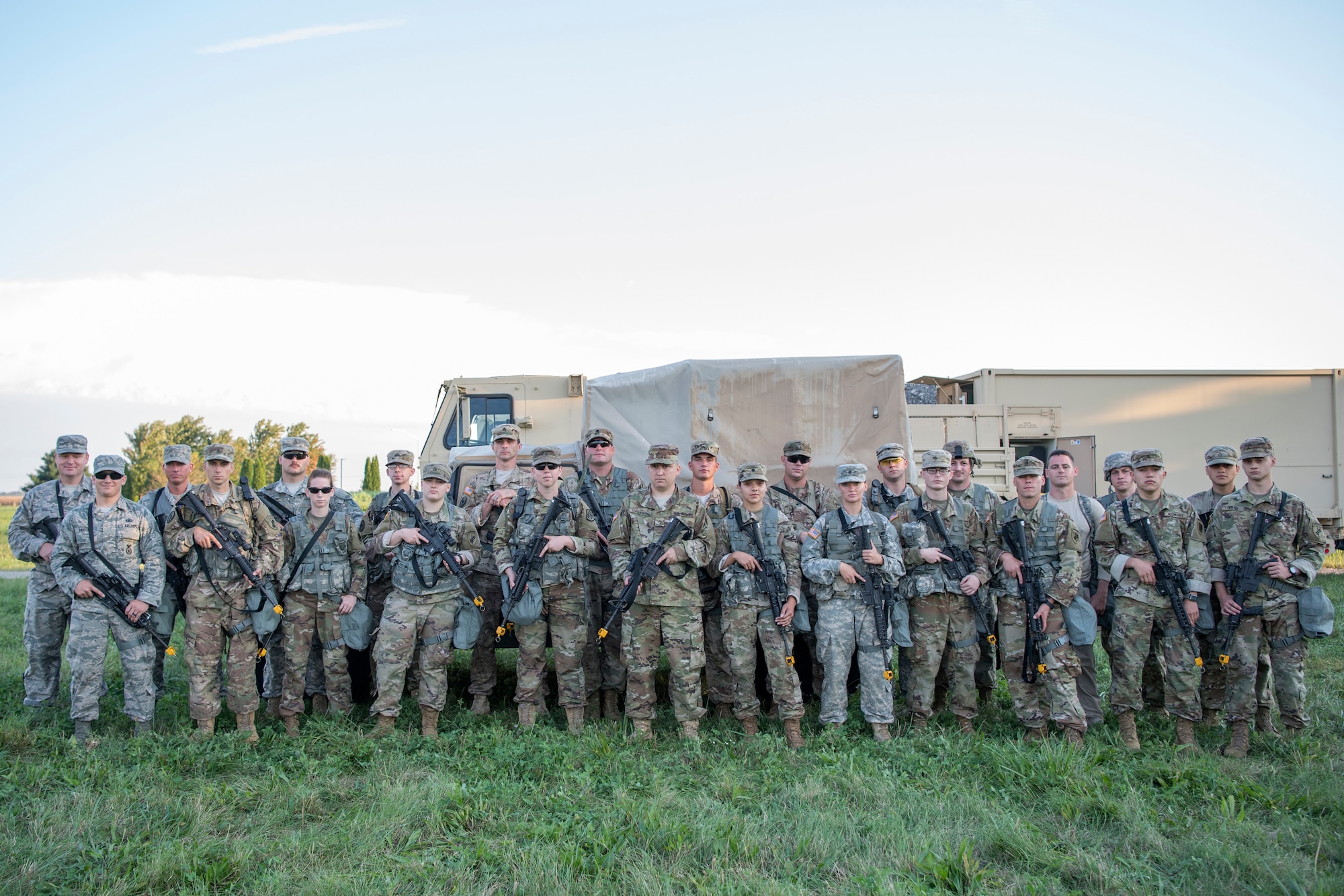 Airmen and Soldiers pose for a photo prior to an Army Warrior Task competition at Grissom Air Reserve Base, Indiana, Sept. 21, 2018. The competition evaluates and scores common combat tasks and helps prepare particiapnts for real-world scenarios that might be encountered in a deployed environment. (U.S. Air Force photo by Tech. Sgt. Ben Mota)