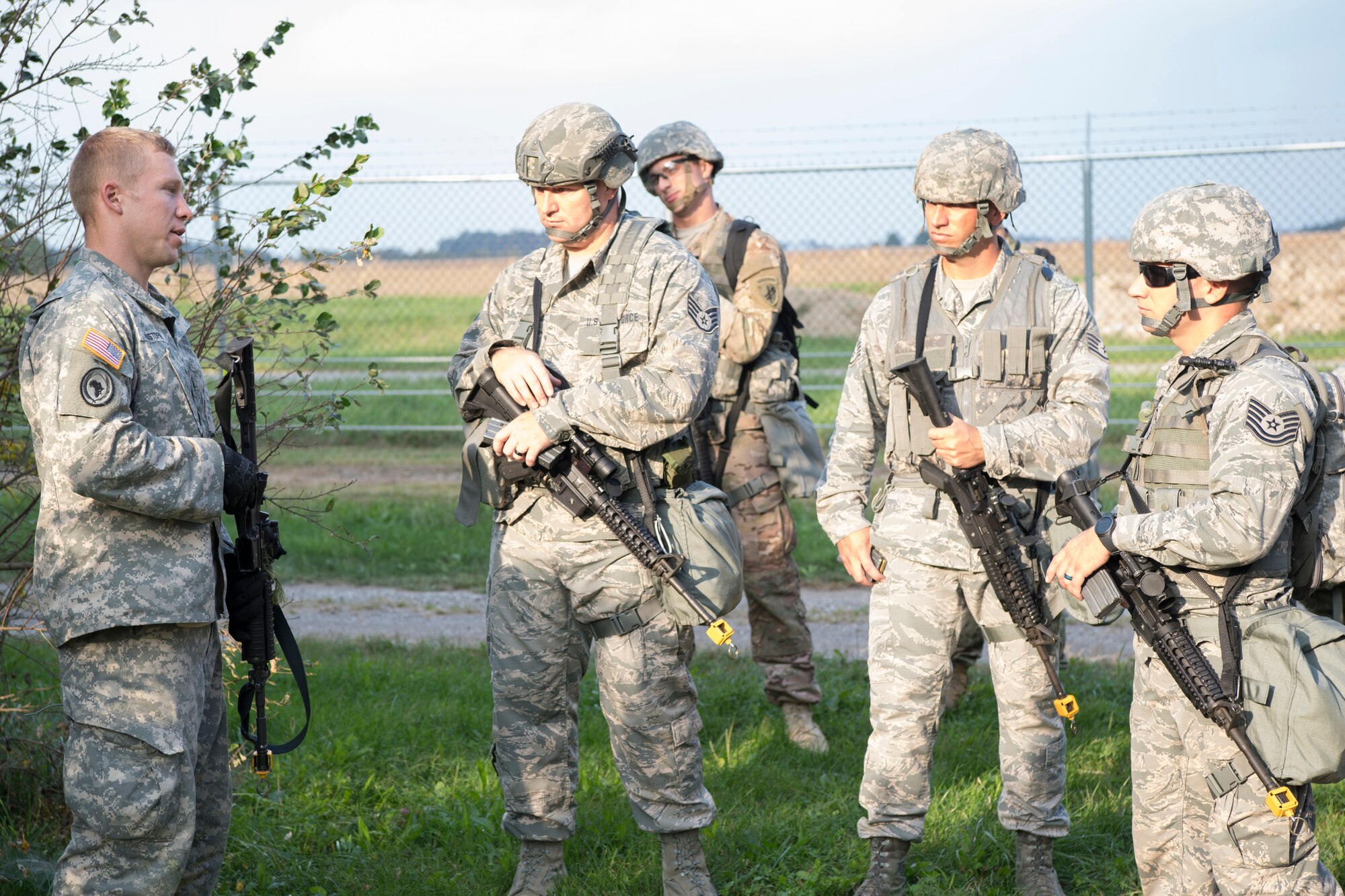 From the left, U.S. Army Spc. Kristen Bowman and Pfc. Jeff Hall, both 316th Psychological Operations Company PSYOP specialists, load ammunition prior to a react to contact exercise during an Army Warrior Task competition at Grissom Air Reserve Base, Indiana, Sept. 21, 2018. During the competition, Soldiers and Airmen worked together to test common combat skills in: hand grenade operations, weapons proficiency, map reading, moving under fire, escalation of force, evaluating and evacuating casualties and use of protective equipment. (U.S. Air Force photo by Tech. Sgt. Ben Mota)