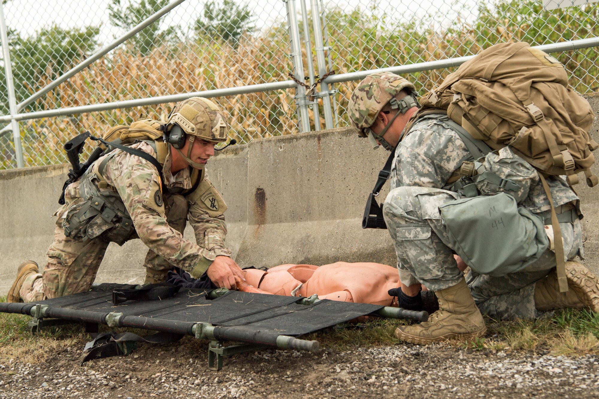 Spc. Mason Seibert, left, and U.S. Army Sgt. Adam Knowles, prepare a mannequin for medical evacuation during an Army Warrior Tasks competition at Grissom Air Reserve Base, Indiana, Sept. 21, 2018. Both soldiers are 316th Psychological Operations Company PSYOP specialists, who along with 11 other 3-man teams participated in the competition. (U.S. Air Force photo by Tech. Sgt. Ben Mota)